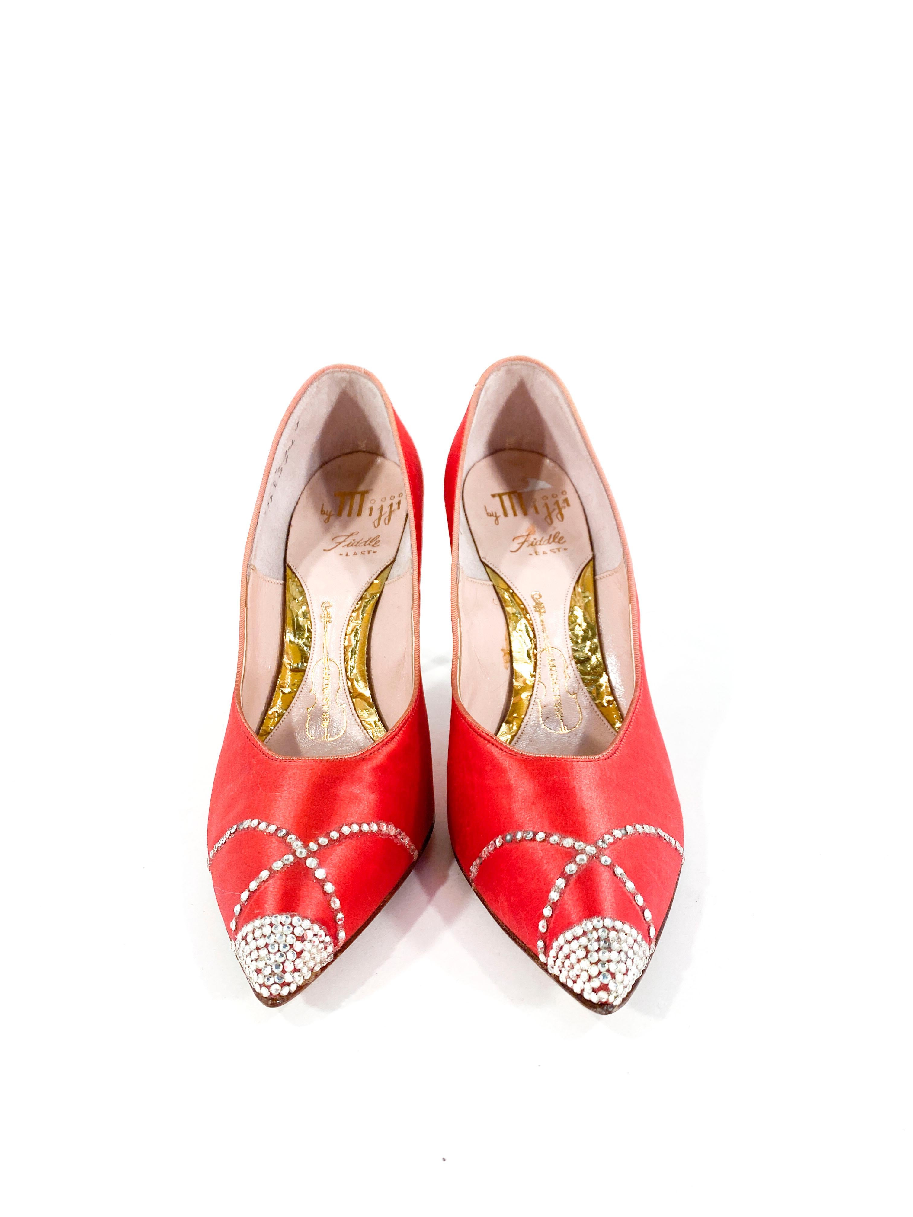 1960s red stain stiletto heels with multi-patterned rhinestone accents on the pointed toe. 