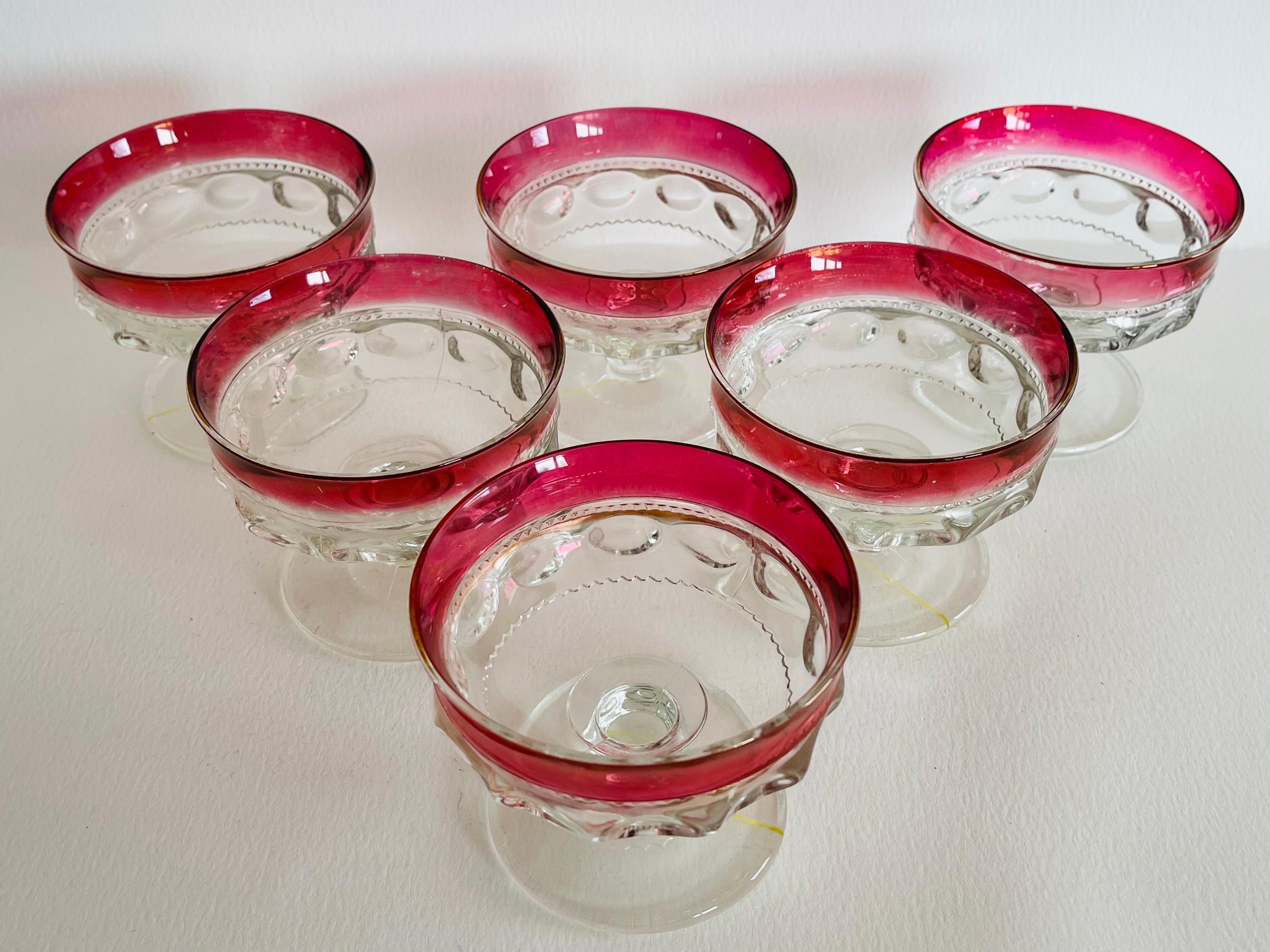 Vintage 1960s set of six red and clear glass thumbprint coupe stems. No marks.