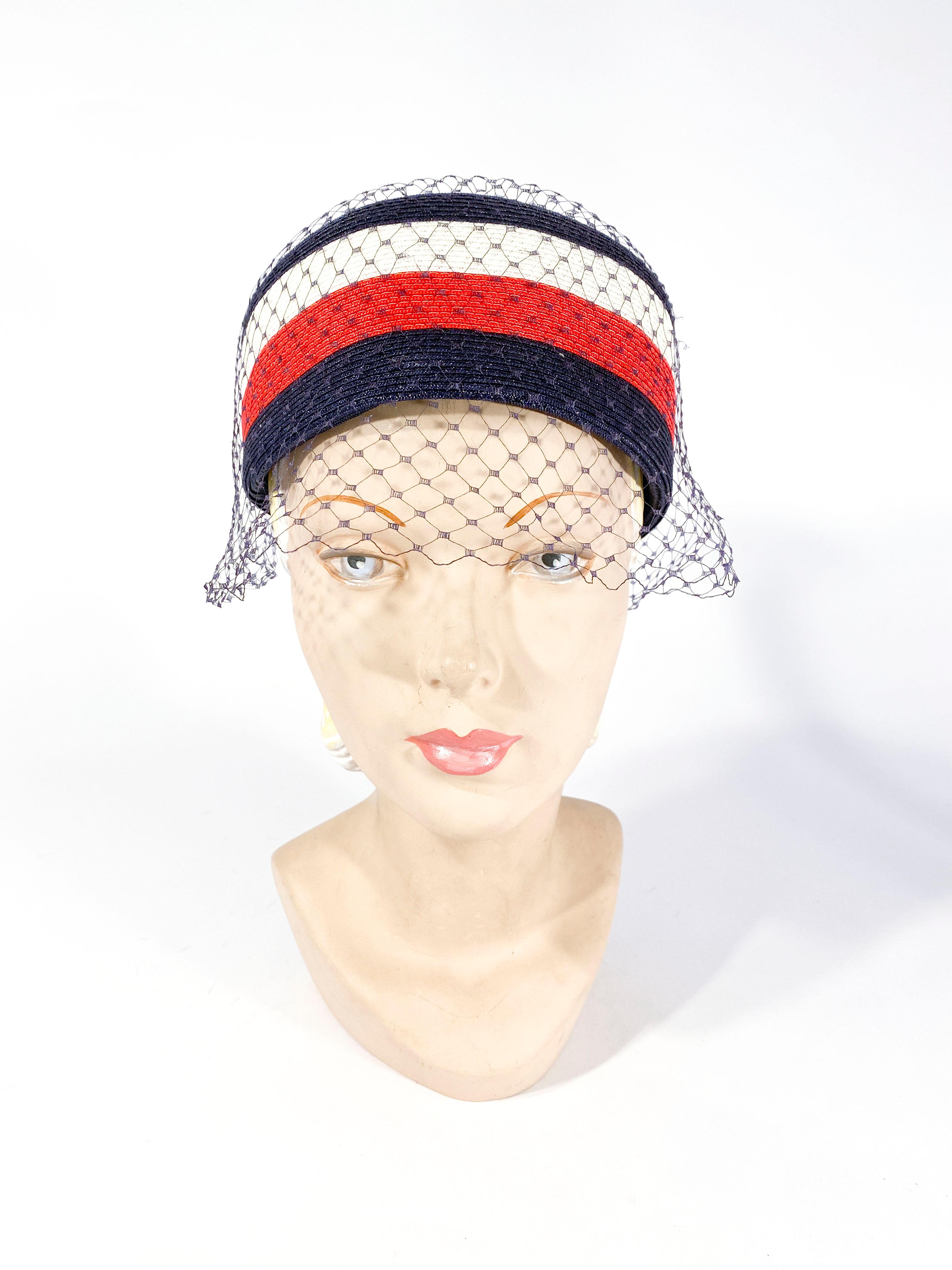 1960s Red, white, and blue coated straw pillbox hat with encasing veil finished with matching decorative bows.