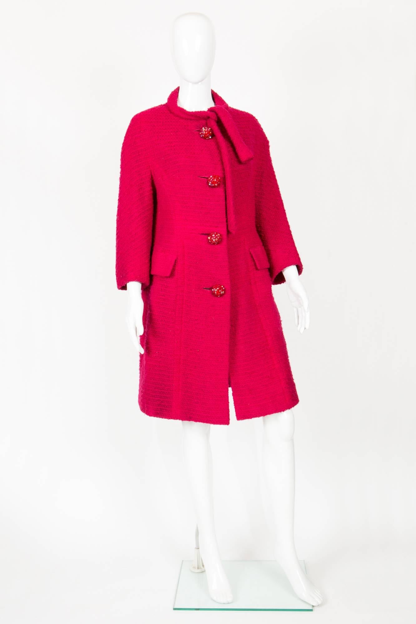 1960s red boucle wool Marie Martine coat featuring gorgeous glass buttons, 3/4 sleeves, a tie neck.  
In good vintage condition. Made in France. 100% wool
Estimated size 38fr/US6 /UK10
We guarantee you will receive this gorgeous item as described