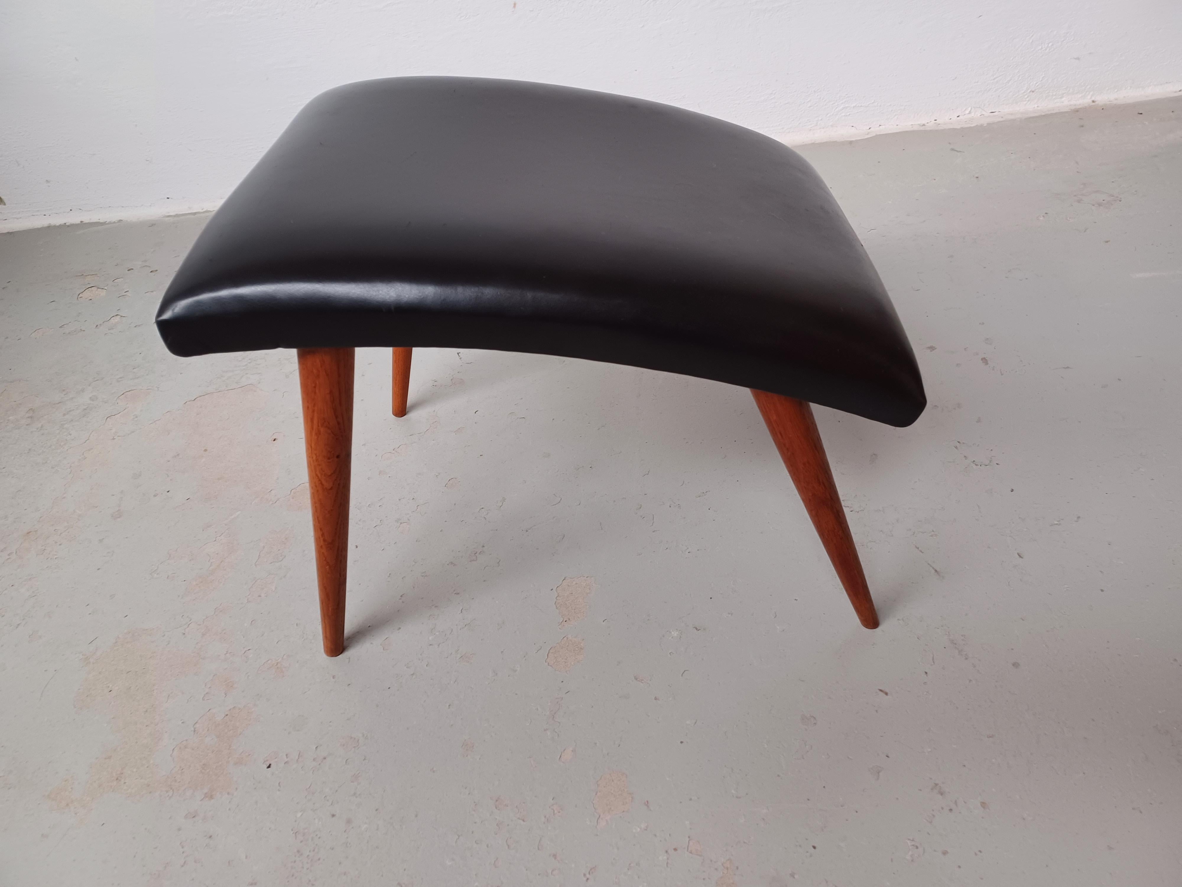 1960's Refinished Danish footstool with leather upholstery.

Danish footstool in slimlined minimalistic yet advanced Scandinavian modern design with it's combination of straight simple lines combined with it's organic curved seat and