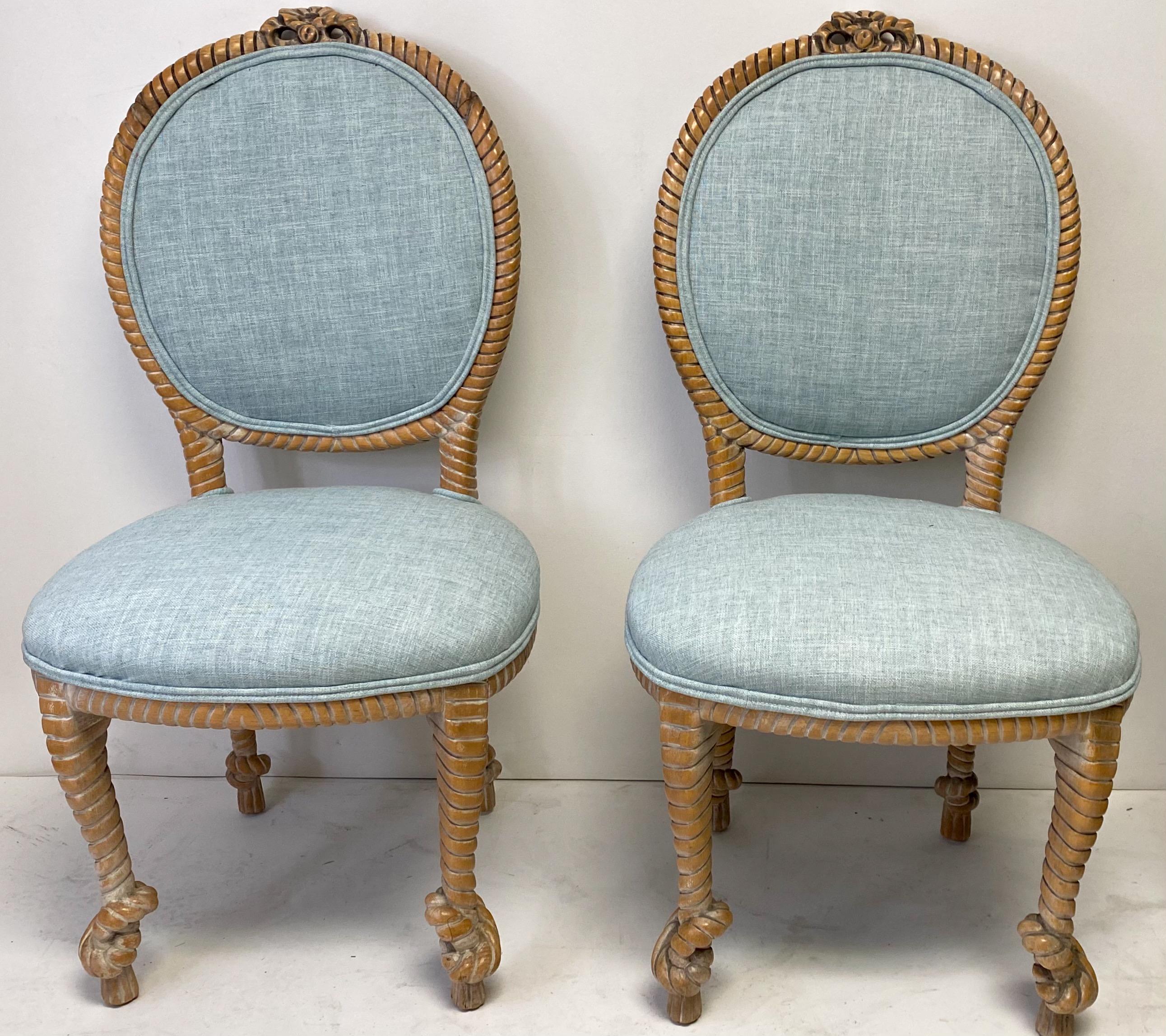 This is a pair of carved oak regency style rope side chairs by Baker Furniture Company. The turquoise linen upholstery is new. They are marked, and the frames do show some lite wear.