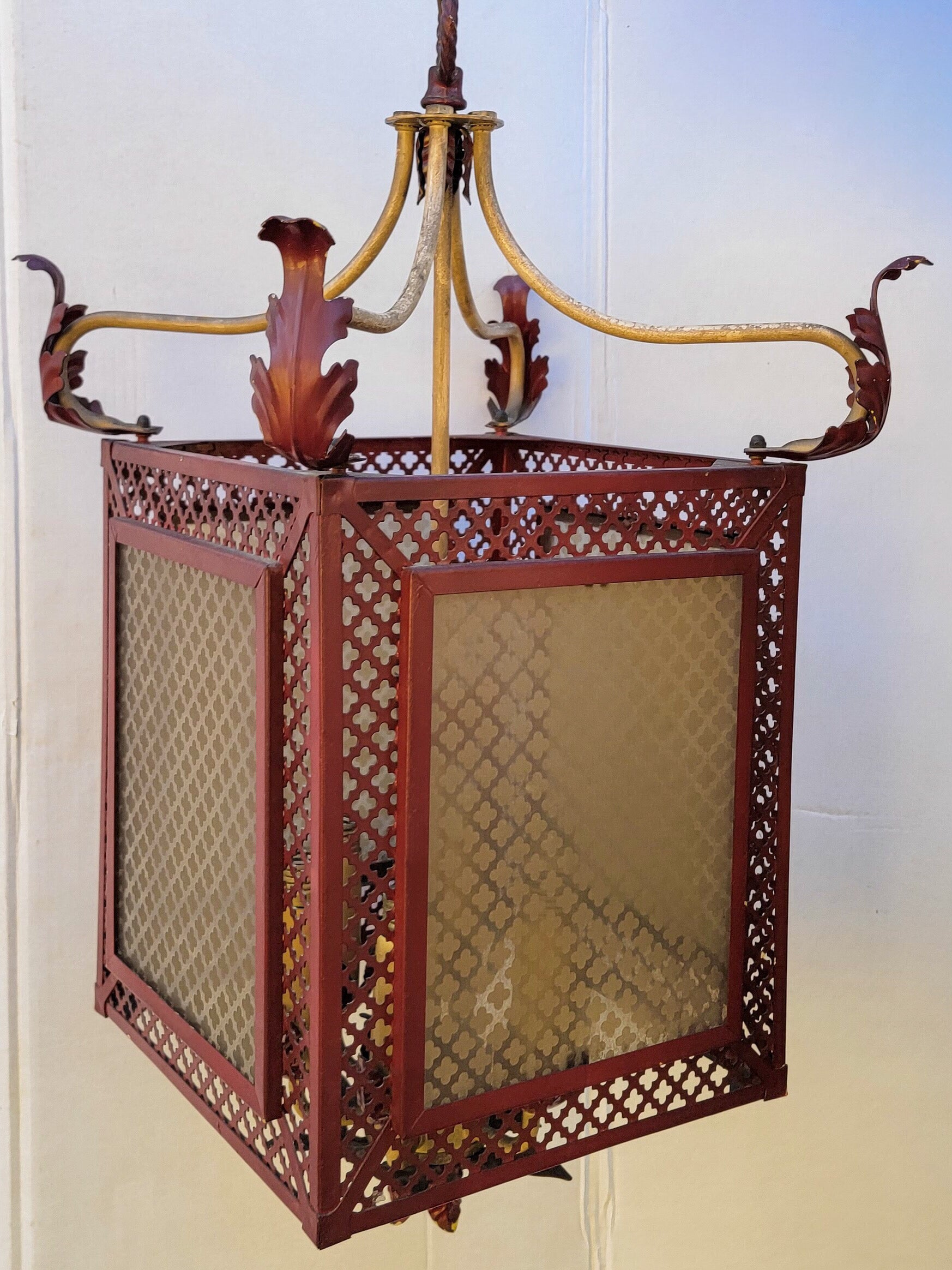 This is an regency style Italian red tole pagoda inspired lantern form chandelier. It dates to the 1960s, and it does have 5 inches of chain. It shows the typical wear that often exists with metal tole.