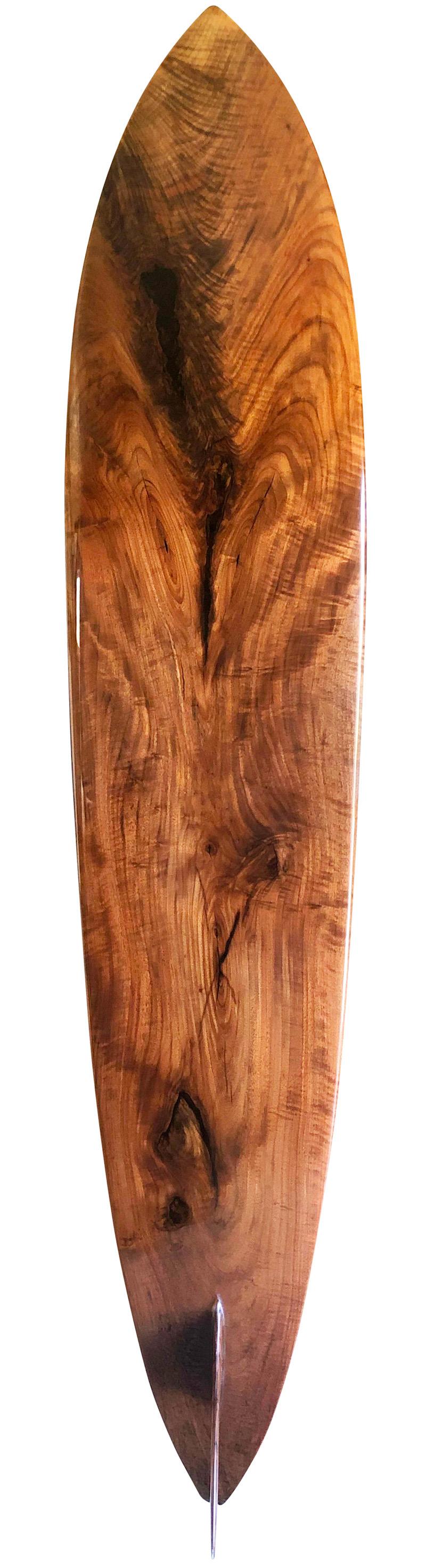 Late-1960s replica Greg Noll Surf Center Hawaii wooden surfboard. Features a transitional-era (late 1960’s style) pintail shape made with one of the rarest and most valuable hardwoods in North America, solid black walnut wood. This trophy surfboard