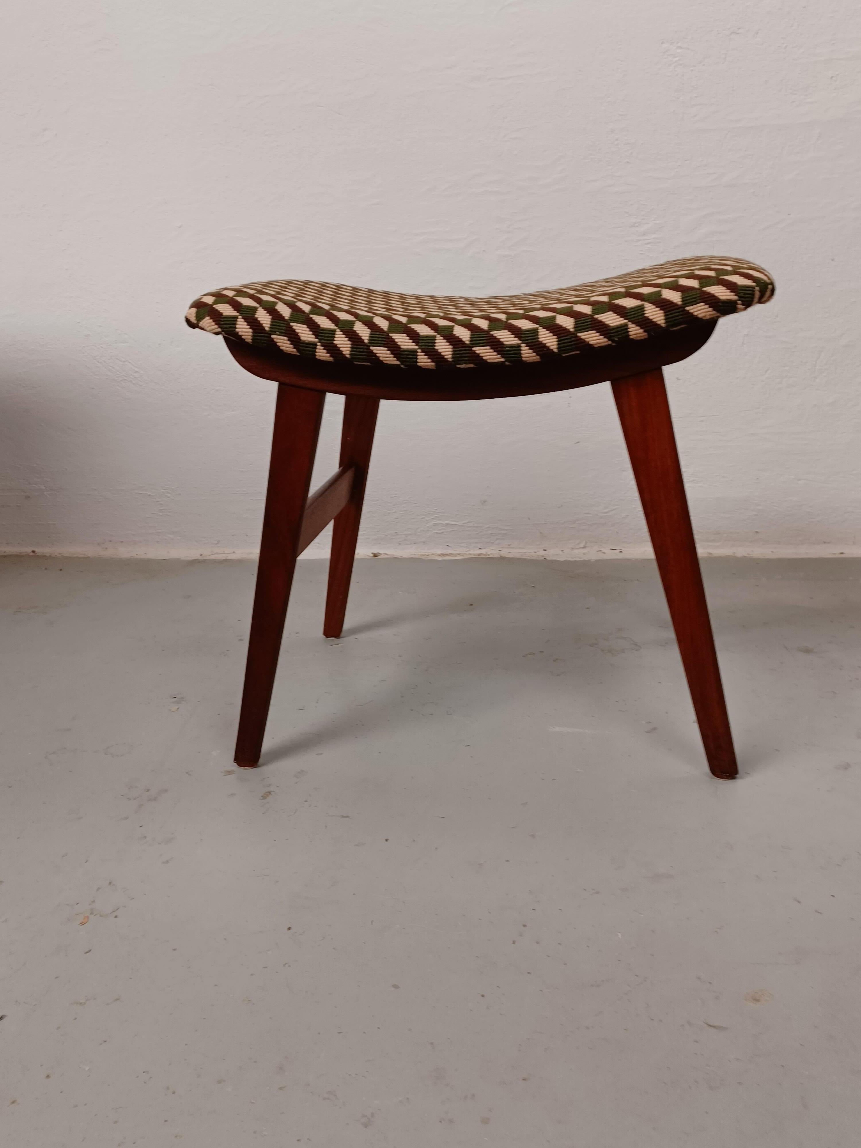 1960's Restored Danish footstool with handmade cross stitch embroidery on the seat.

Fully restored Danish footstool in slimlined minimalistic yet advanced Scandinavian modern design with it's combination of straight simple lines combined with