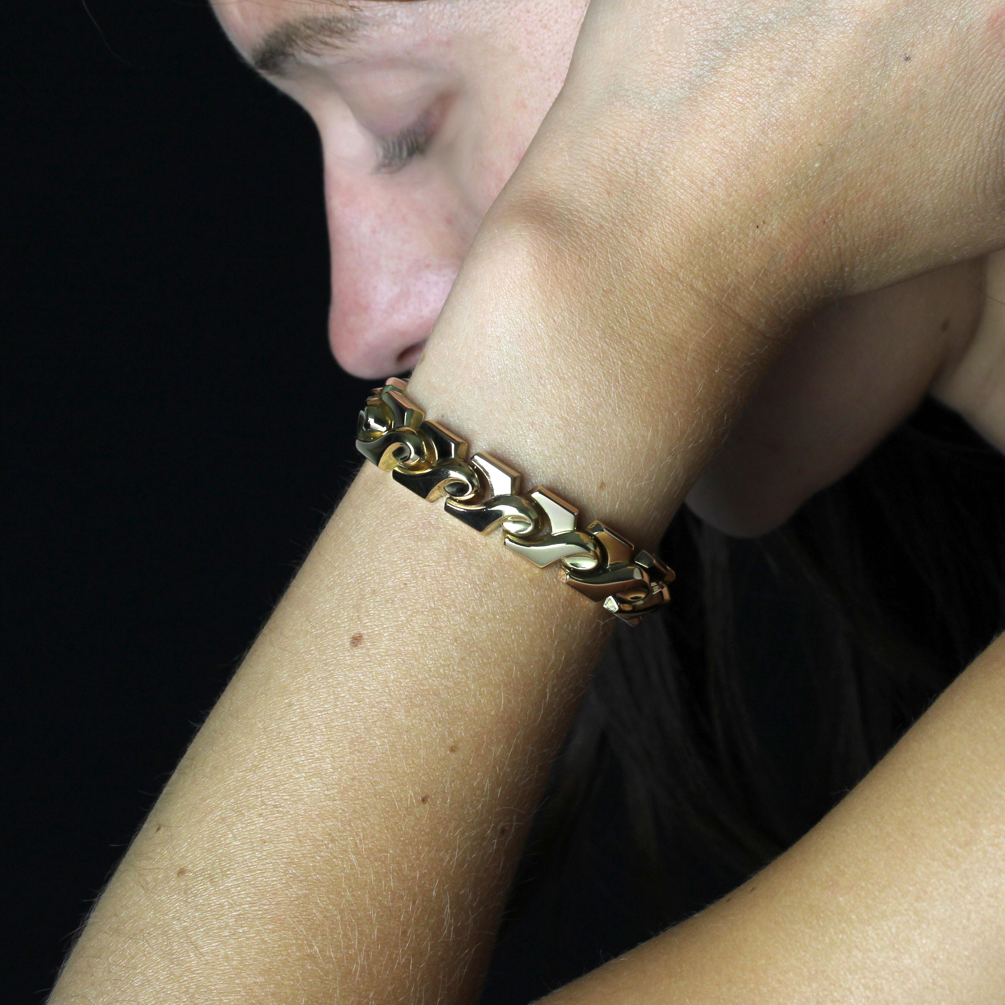 Bracelet in 18 karat rose gold, eagle head hallmark. 
Originally an antique watch, this vintage piece of jewelry has been transformed into a yellow gold bracelet, featuring slightly curved, interconnected geometric knot motifs. The interior of the