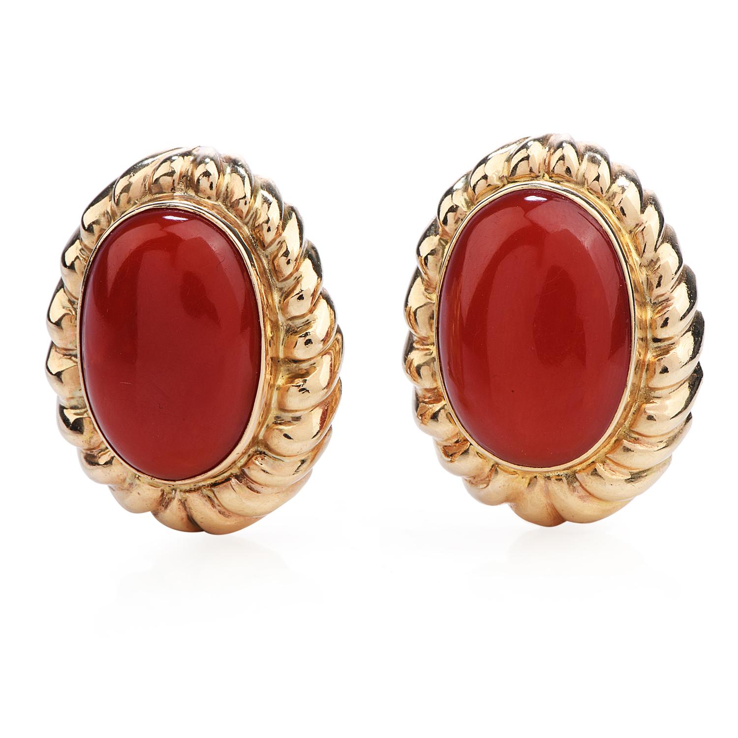 These 1980's  Natural Red coral earrings are crafted in solid 14-karat yellow gold, weighing 16.5 grams and measuring 22mm long x 17mm wide. Showcasing a pair of bezel-set natural Ox-Blood Red coral oval cabochons. Secure with clip-on back.

Remain