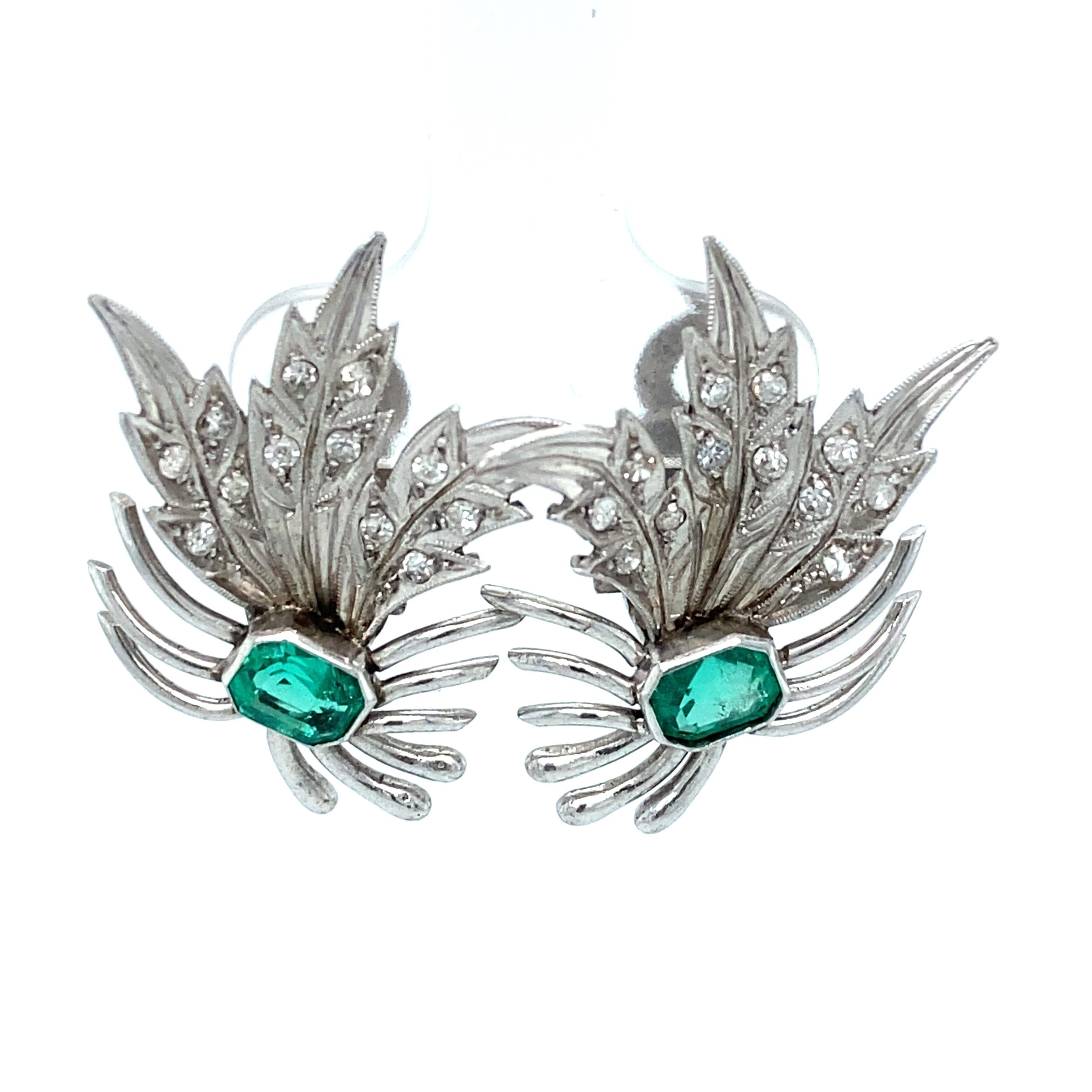 Item Details: These unique retro earrings have a feather design with emeralds and diamonds.

Circa: 1960s
Metal Type:  18 karat white gold
Weight: 7.6 grams
Size: 1 inch length 

Emerald Details:

Carat: Approximately 1.0 carat total weight
Shape: