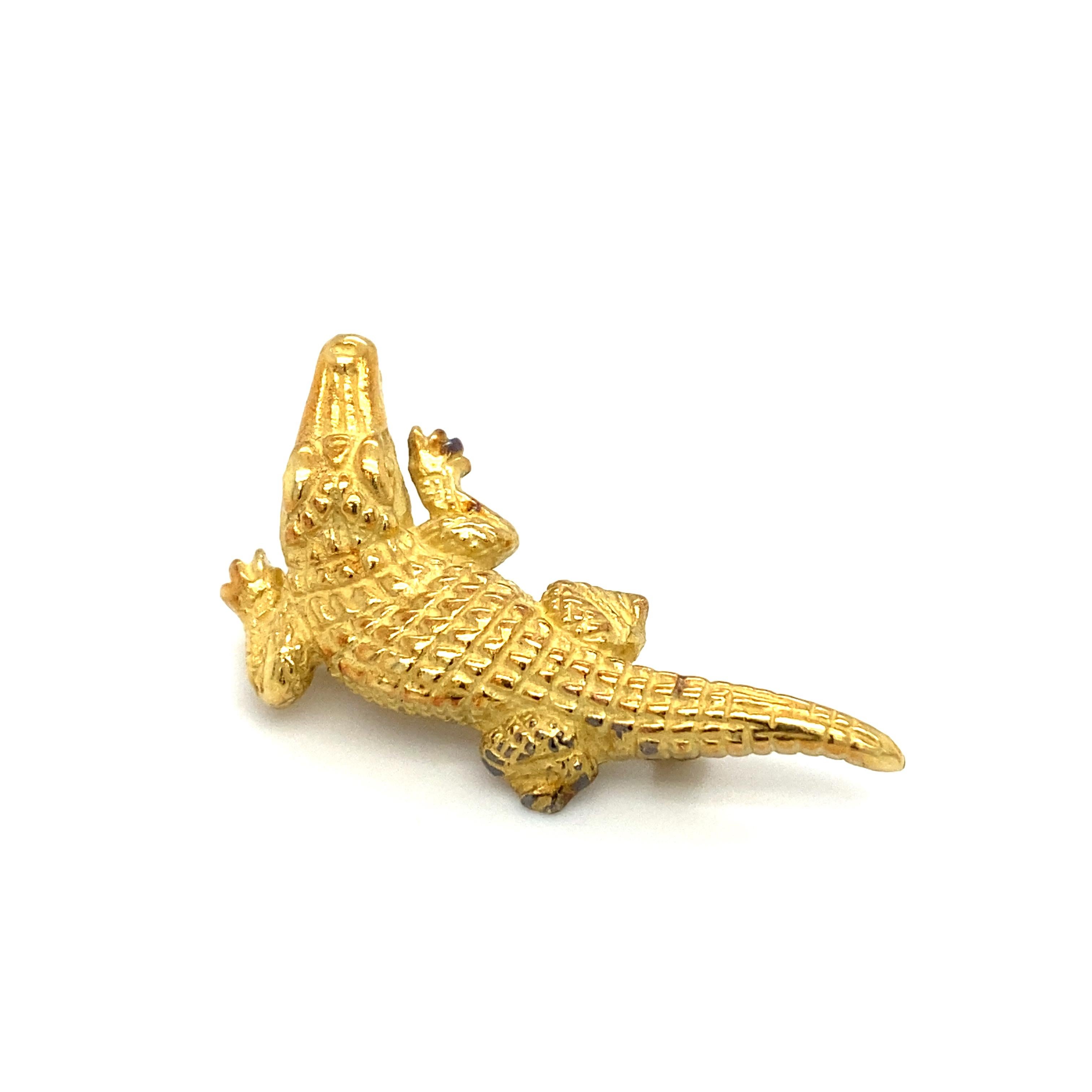Item Details: This whimsical alligator brooch is finely crafted in 18 Karat Yellow Gold. It features textured gold to display the scales on the alligator's body. Very well crafted brooch!

Circa: 1960s
Metal Type: 18 Karat Yellow Gold
Weight: 8.8