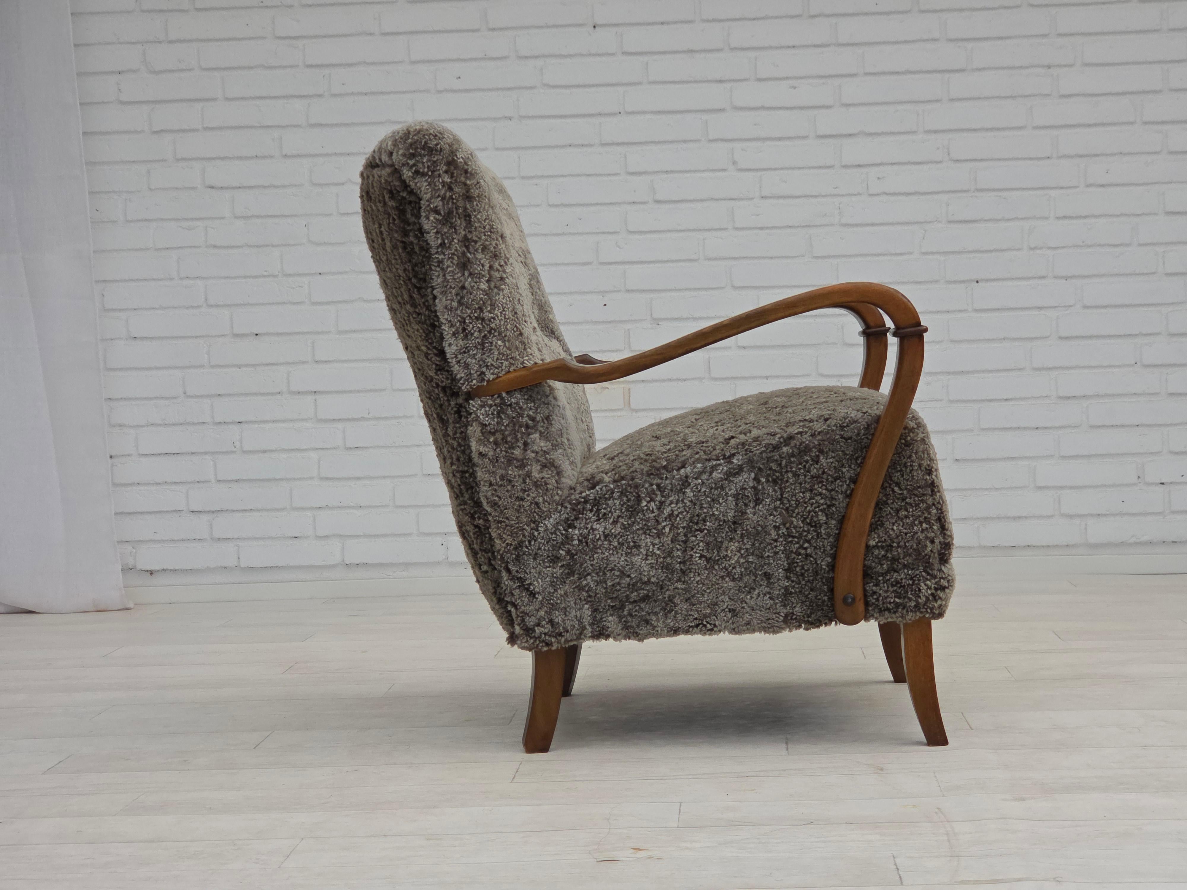 Mid-20th Century 1960s, reupholstered Danish armchair, New Zealand genuine sheepskin. For Sale