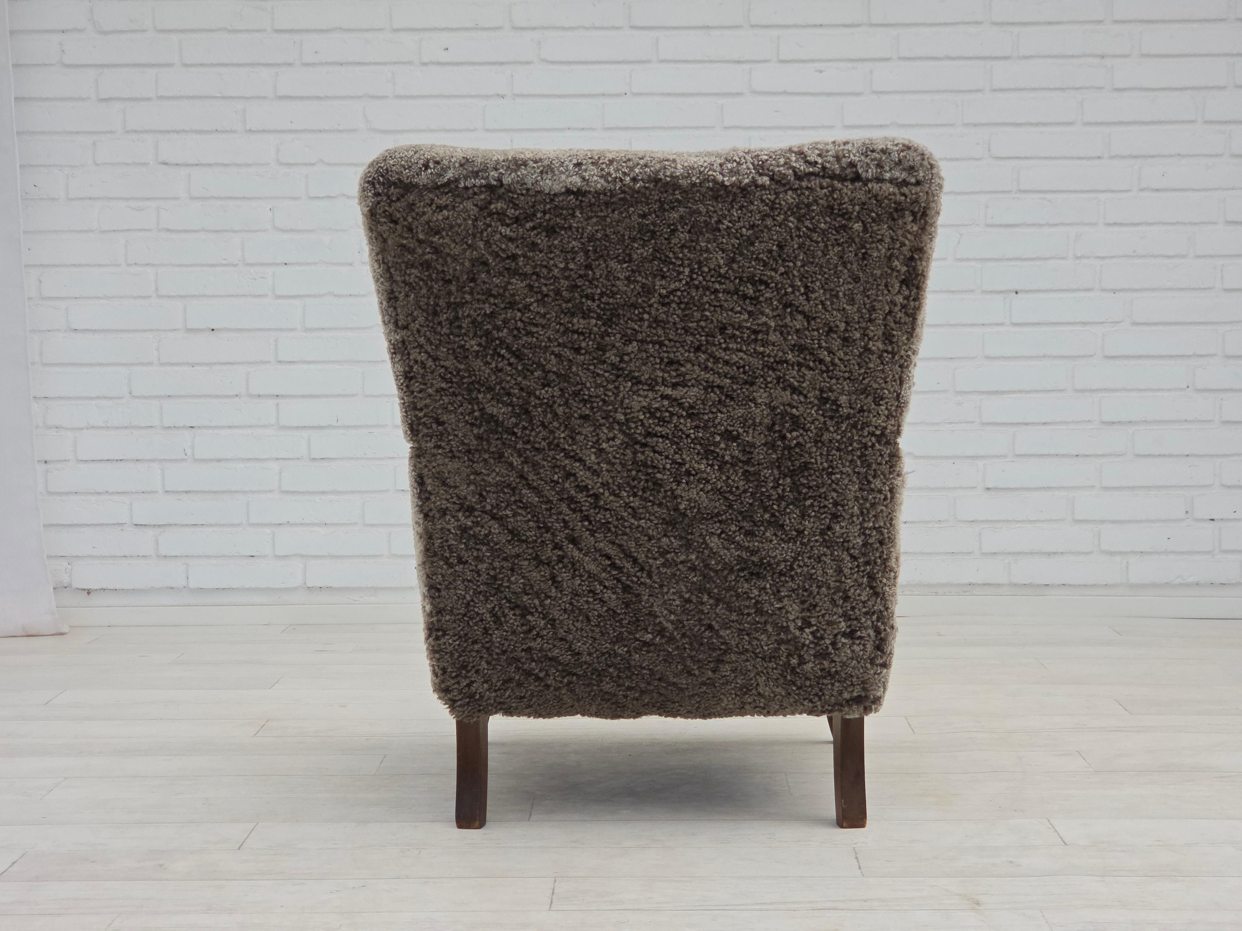1960s, reupholstered Danish armchair, New Zealand genuine sheepskin. For Sale 1