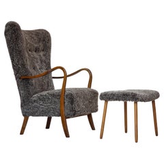1960s, reupholstered Danish armchair, with stool, genuine sheepskin.