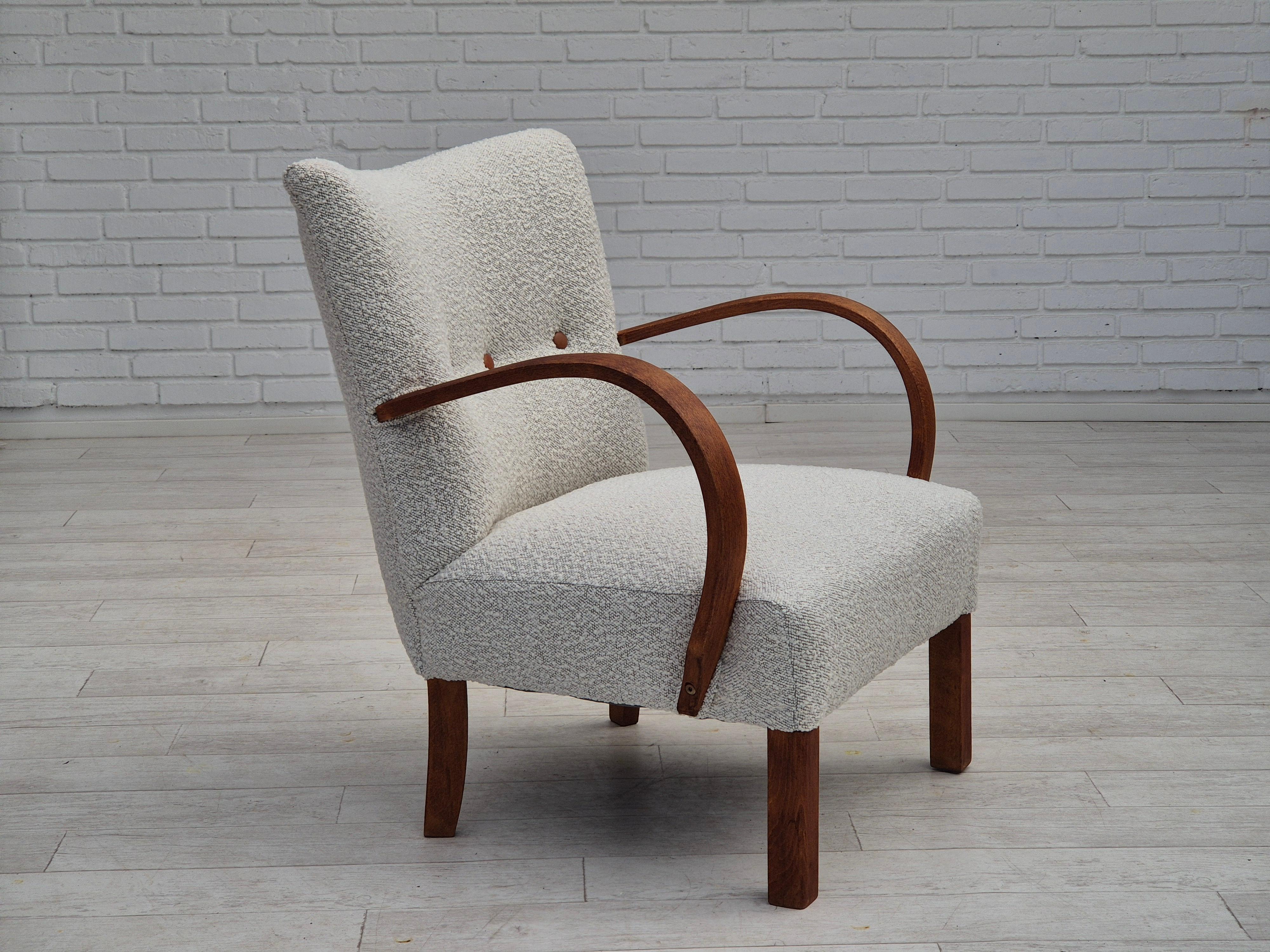 1960s, Danish art-deco armchair. Reupholstered in quality light grey/white furniture fabric, leather buttons. Renewed beech wood armrest and legs. Brass springs in the seat are retained. Reupholstered by professional upholsterer, craftsman.