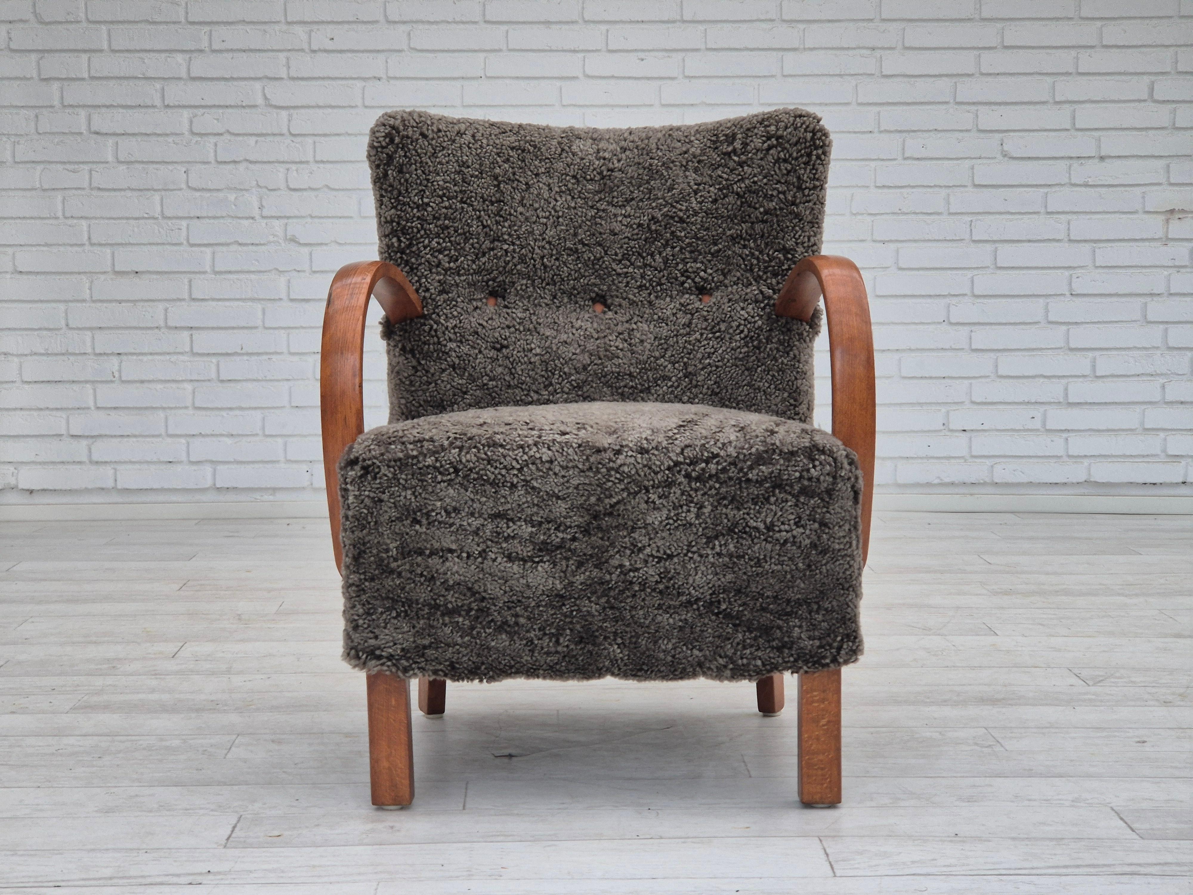 1960s, completely renovated-reupholstered Danish art deco armchair. Quality New Zealand genuine sheepskin 