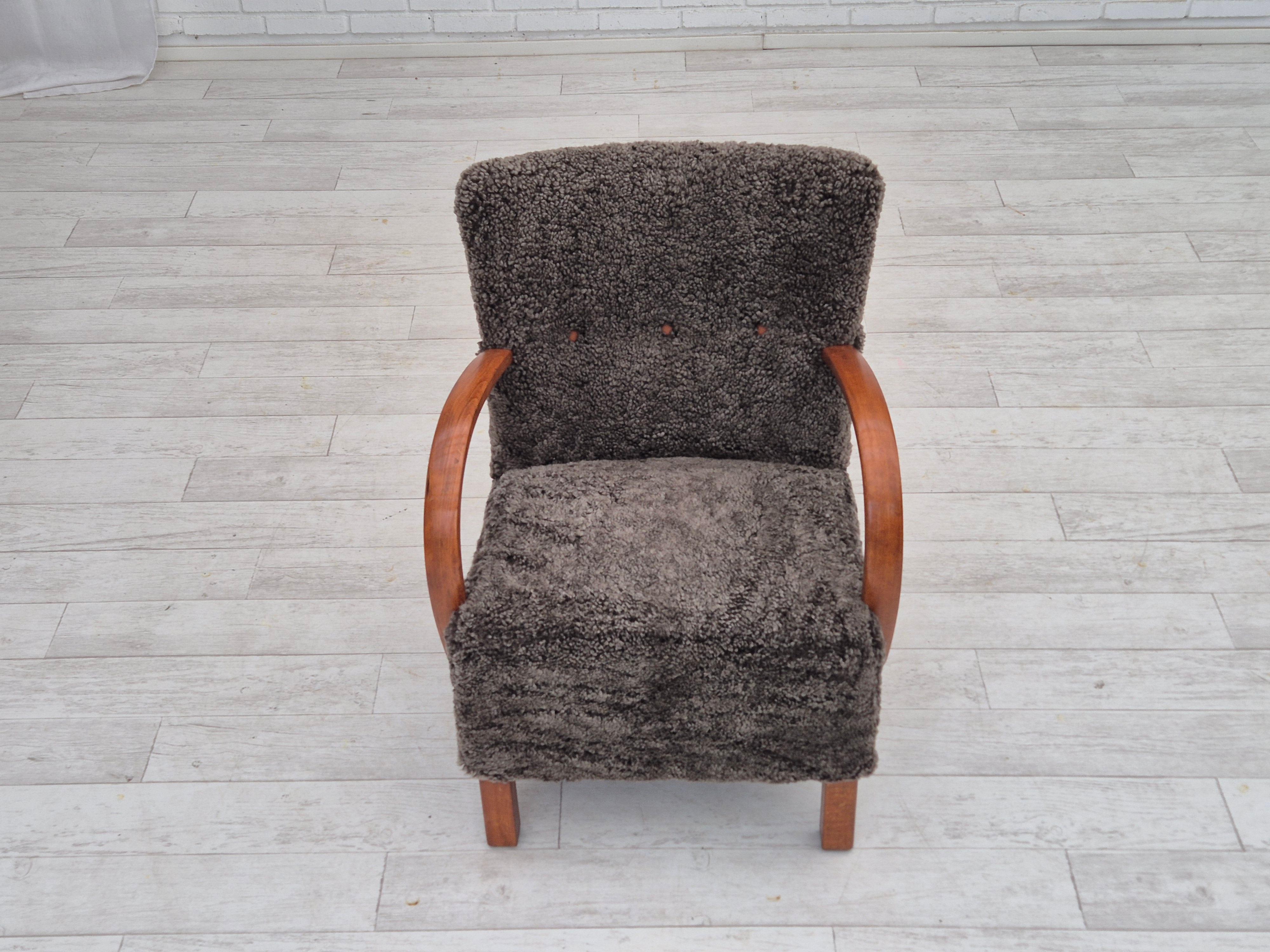 Scandinavian Modern 1960s, reupholstered Danish art deco armchair, genuine New Zealand sheepskin. For Sale