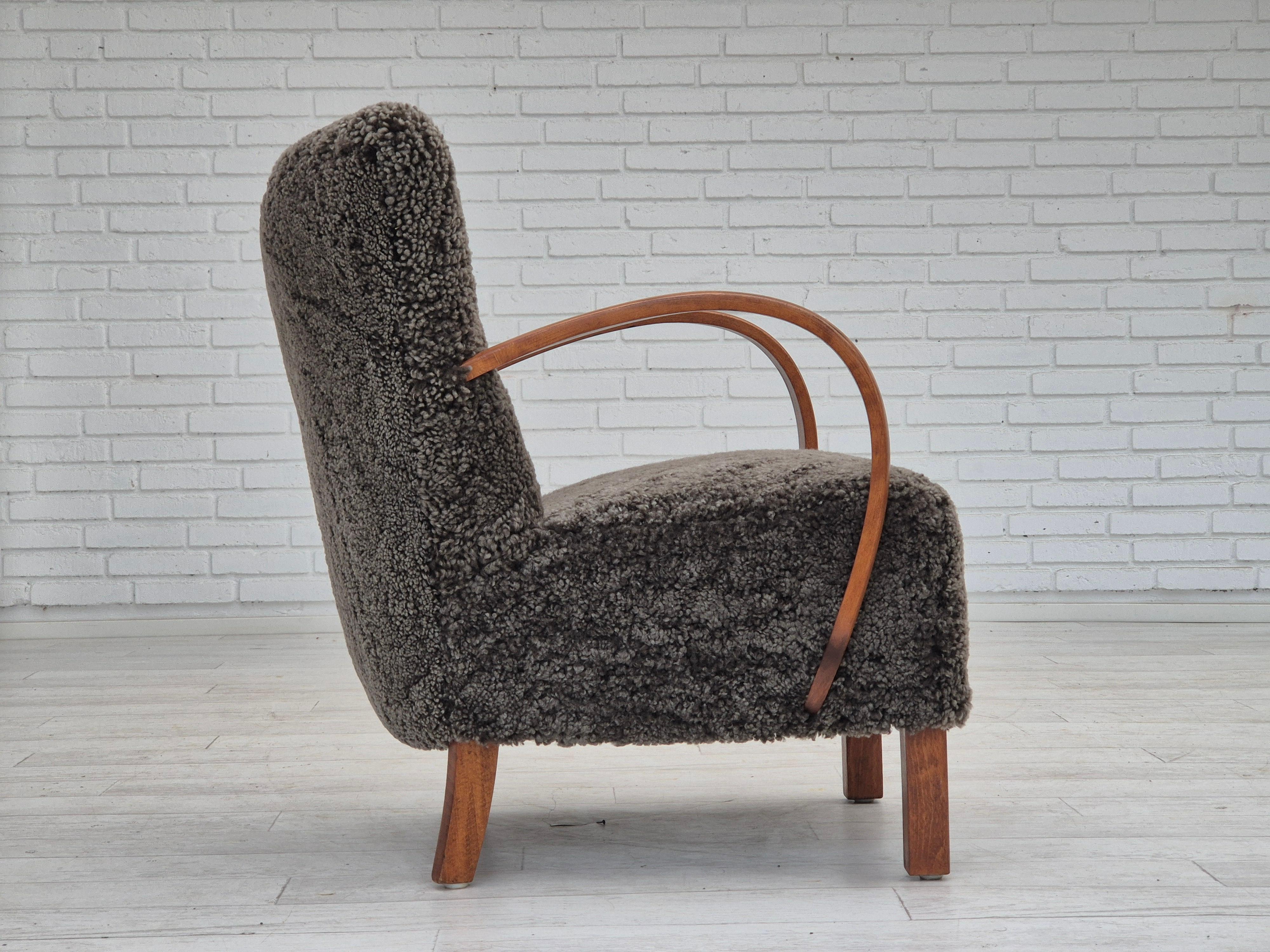 1960s, reupholstered Danish art deco armchair, genuine New Zealand sheepskin. In Good Condition For Sale In Tarm, 82