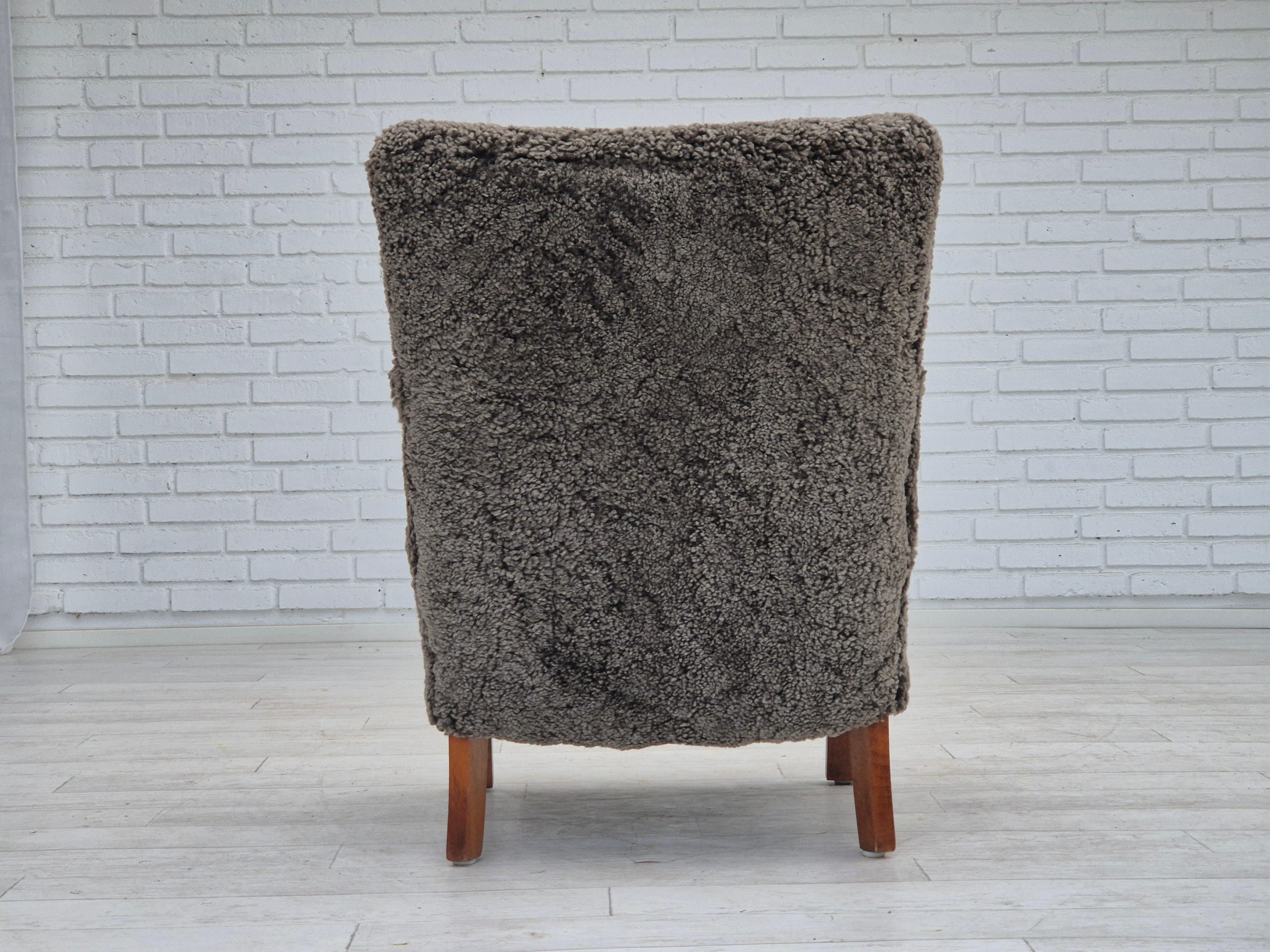 Mid-20th Century 1960s, reupholstered Danish art deco armchair, genuine New Zealand sheepskin. For Sale