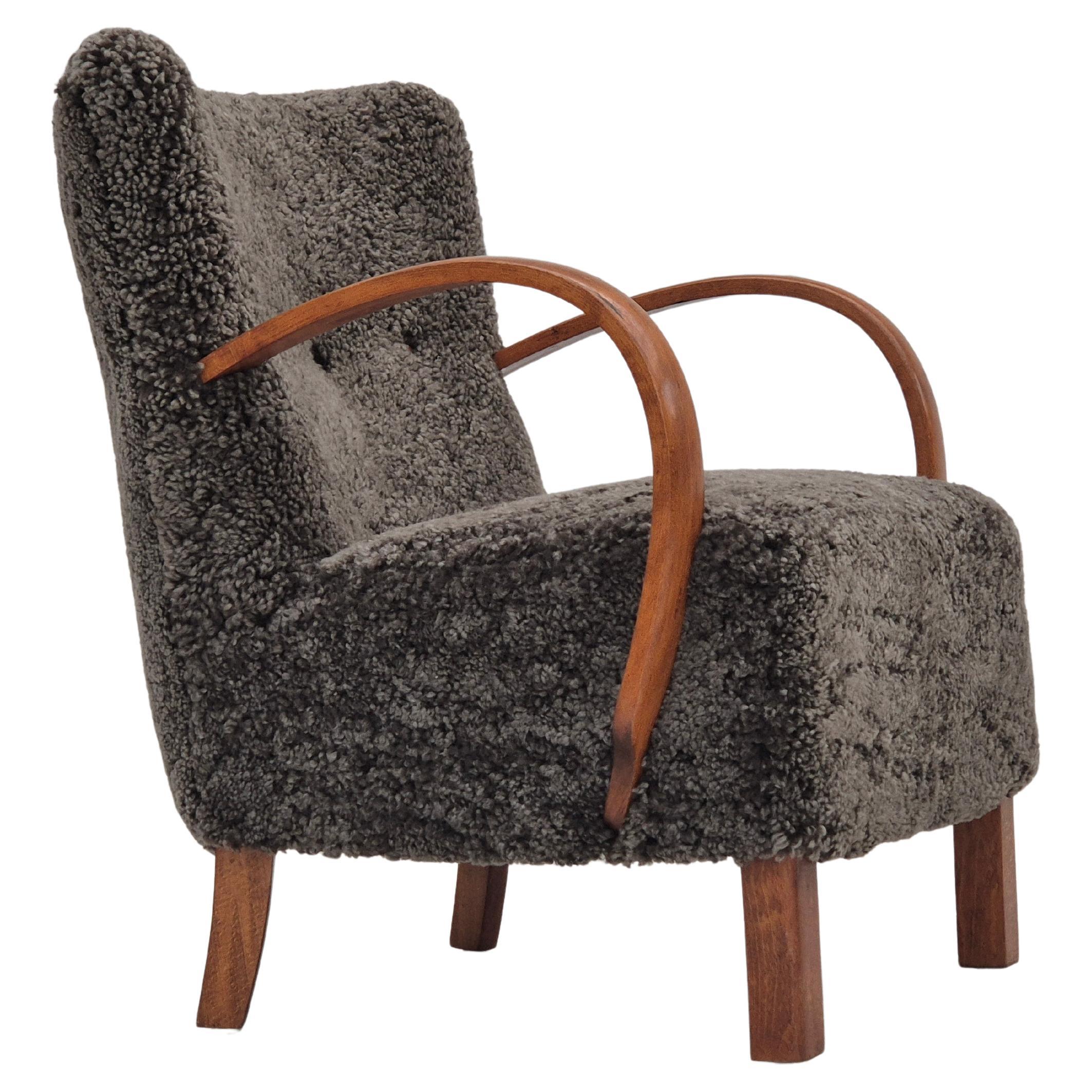 1960s, reupholstered Danish art deco armchair, genuine New Zealand sheepskin. For Sale