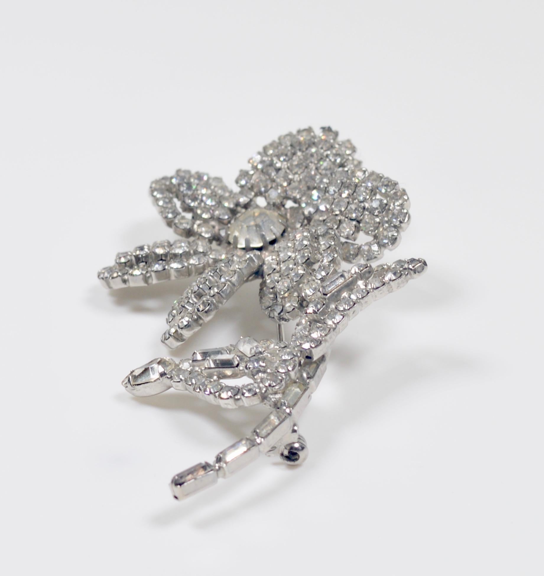 A very beautiful of fine quality rhinestone brooch on silver depicting a flower stem with two leaves