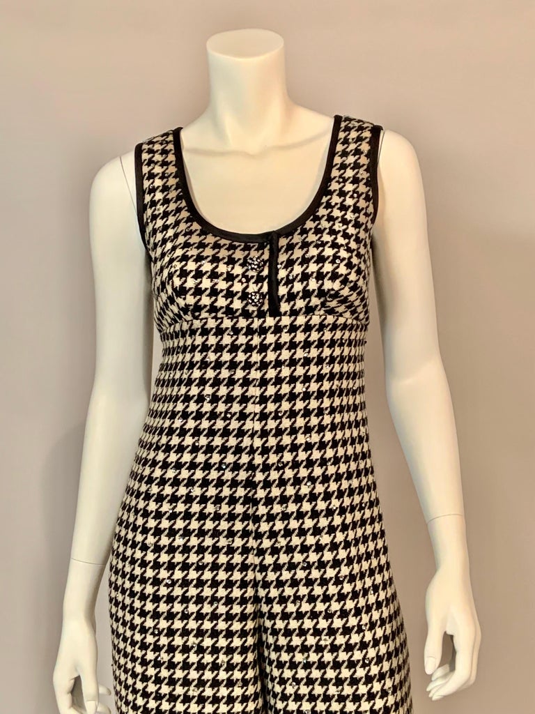 Morton Myles designed this very unusual jumpsuit, starting with a black and cream wool in a houndstooth weave. He trimmed the neckline and arm holes with black satin and, added two rhinestone studded buttons at the center front and pockets in the
