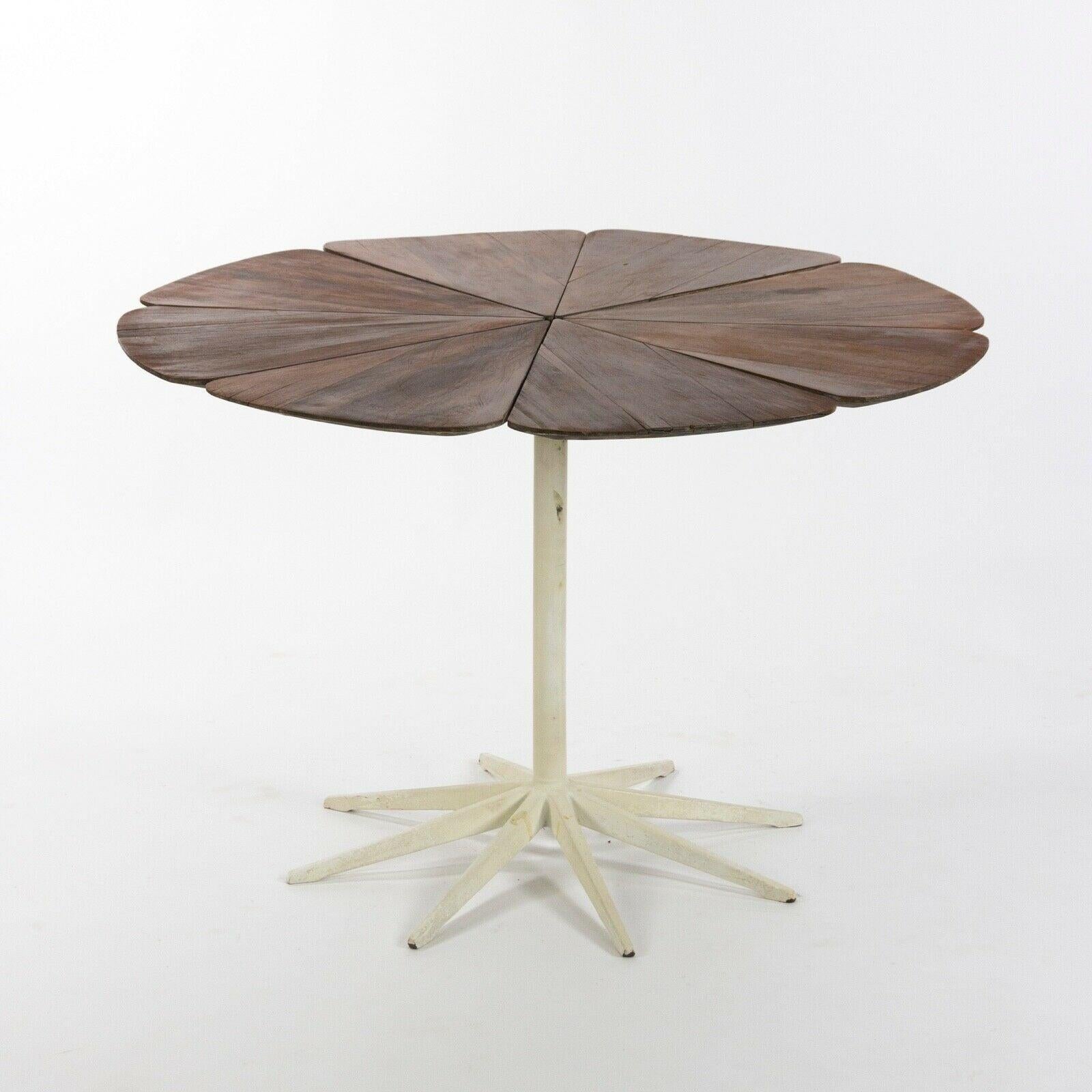 Listed for sale is an exceptionally rare vintage petal dining table, produced by Knoll and Designed by Richard Schultz.
This table has a fabulous patina to the redwood top. It is an earlier piece from the 1960's. As a result, the redwood carries