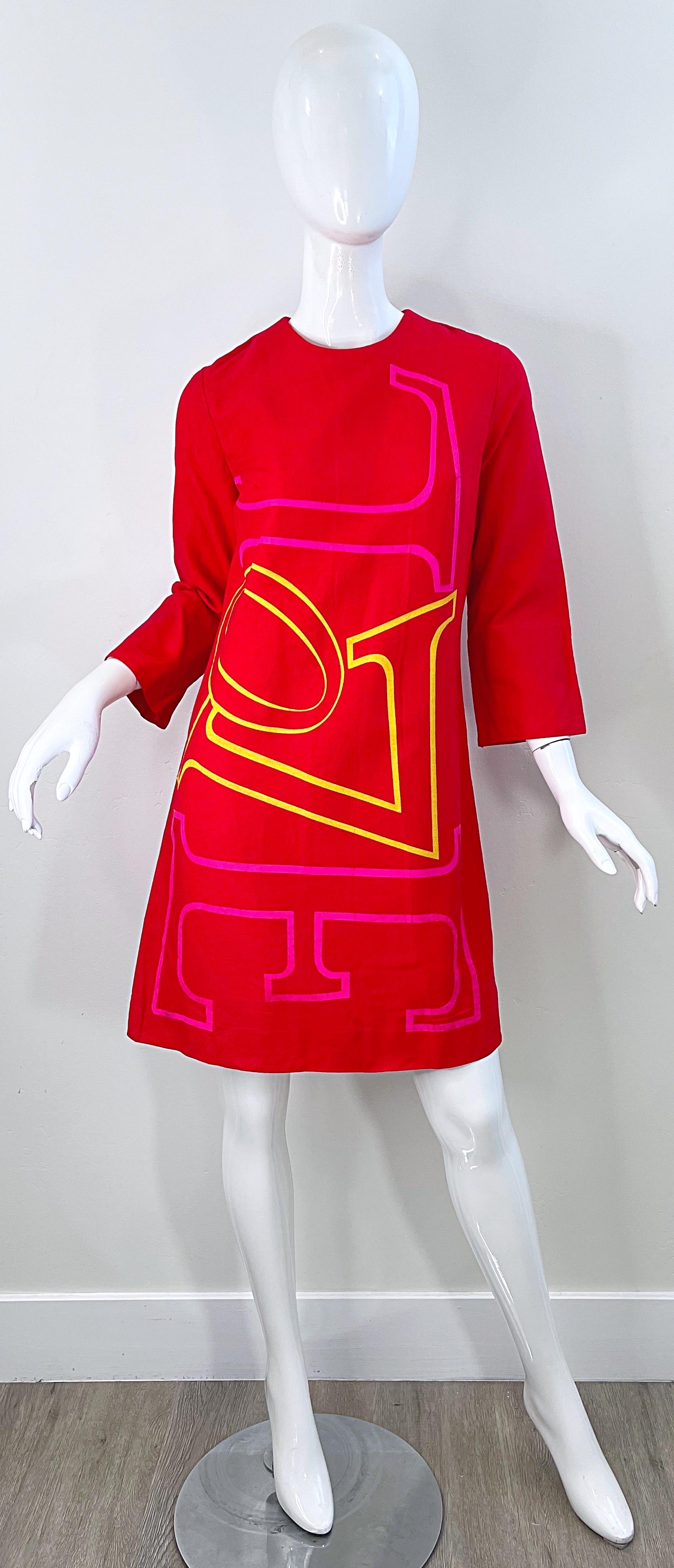 Rare and super chic ROBERT INDIANA print ‘ LOVE ‘ red shift dress ! Love is hand painted in bold pink and yellow paint. Hidden metal zipper up the back with hook-nd-eye closure. 
A great statement piece that will only increase in value with time.
In