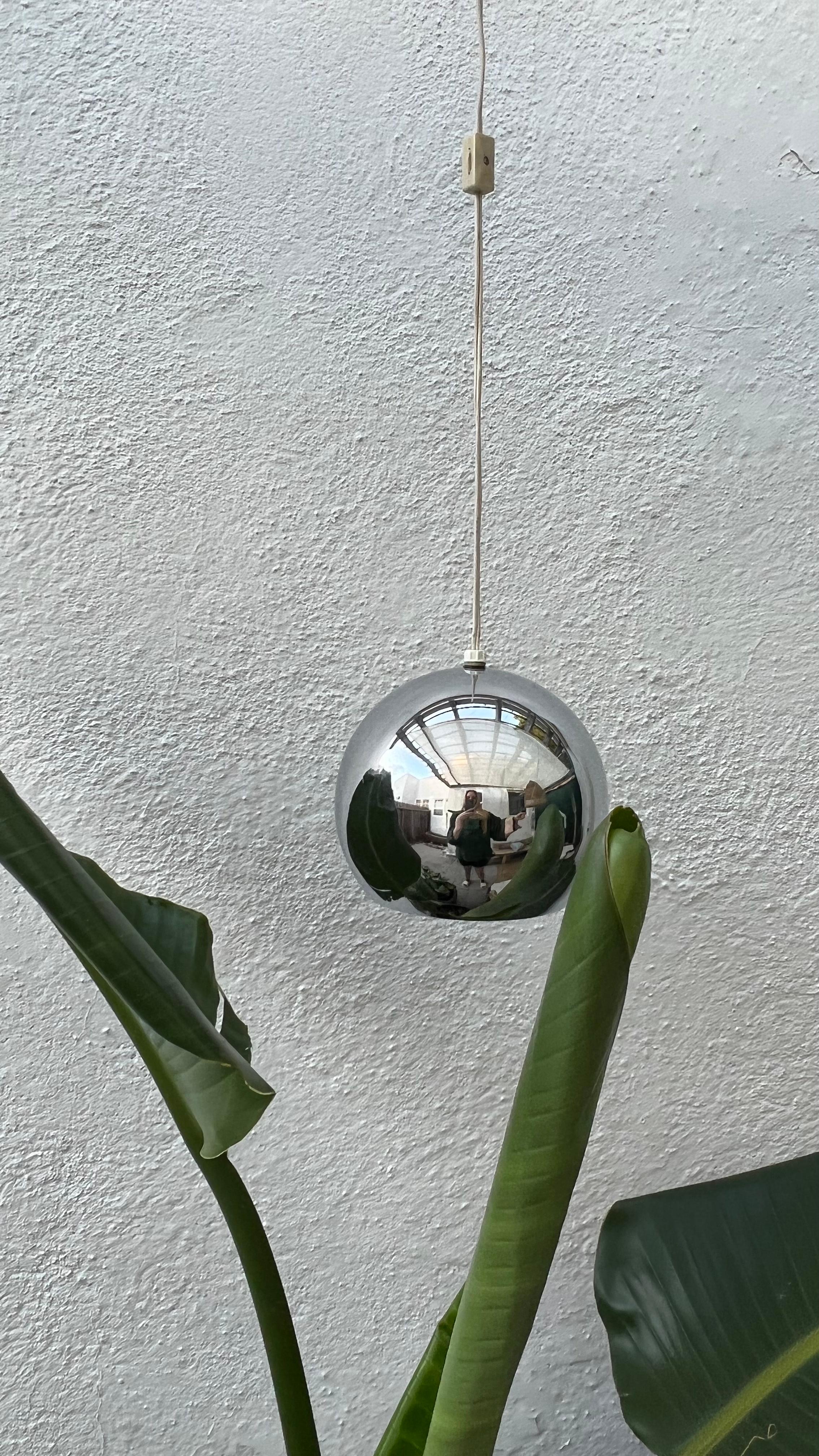 A modernist 1960s round chrome pendant by Robert Sonneman. This pendant plugs into the wall and has a cord switch to turn it on and off. Since this pendant doesn't require hardwiring, you can move it any time you feel like rearranging your space.
