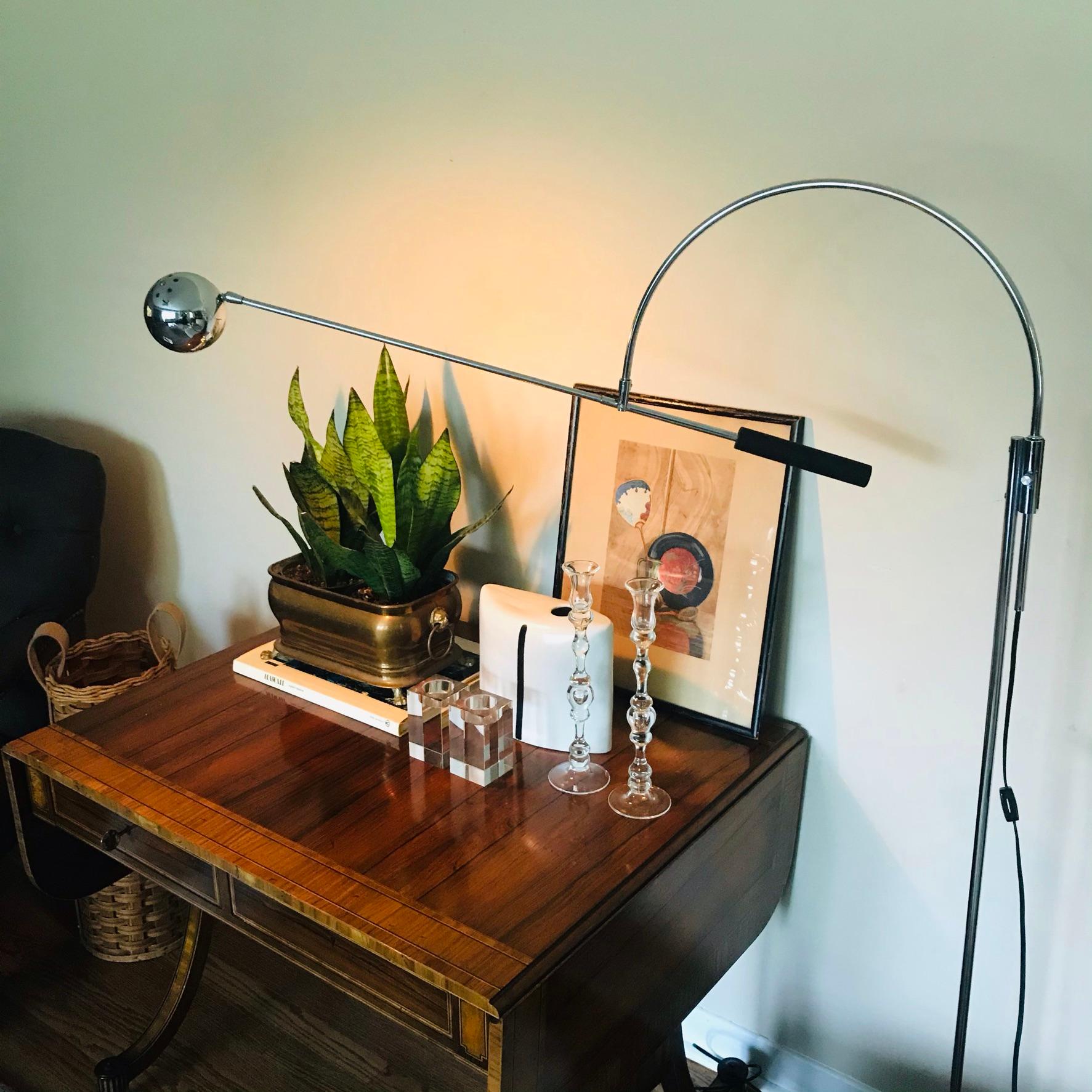 Amazing 60s architectural chrome arch floor lamp by Robert Sonneman. Known as the “Orbiter”, the design offers an articulating arm and eye socket. All original hardware. Chrome newly restored and in working. The floor lamp will provide a vintage