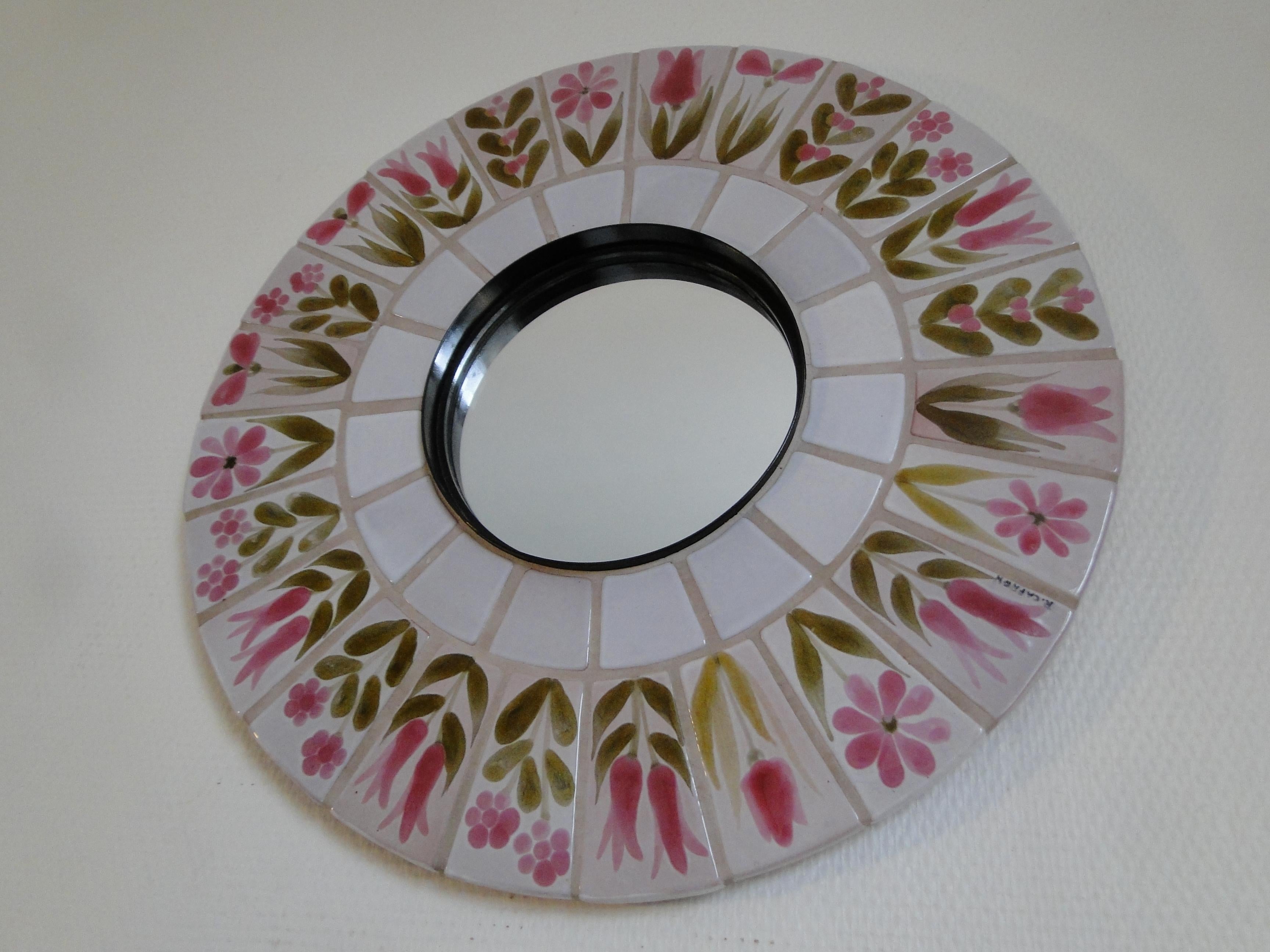 Ceramic mirror by Roger Capron from the 60s.

Pink and green floral decor in vibrant colors

Very good condition.