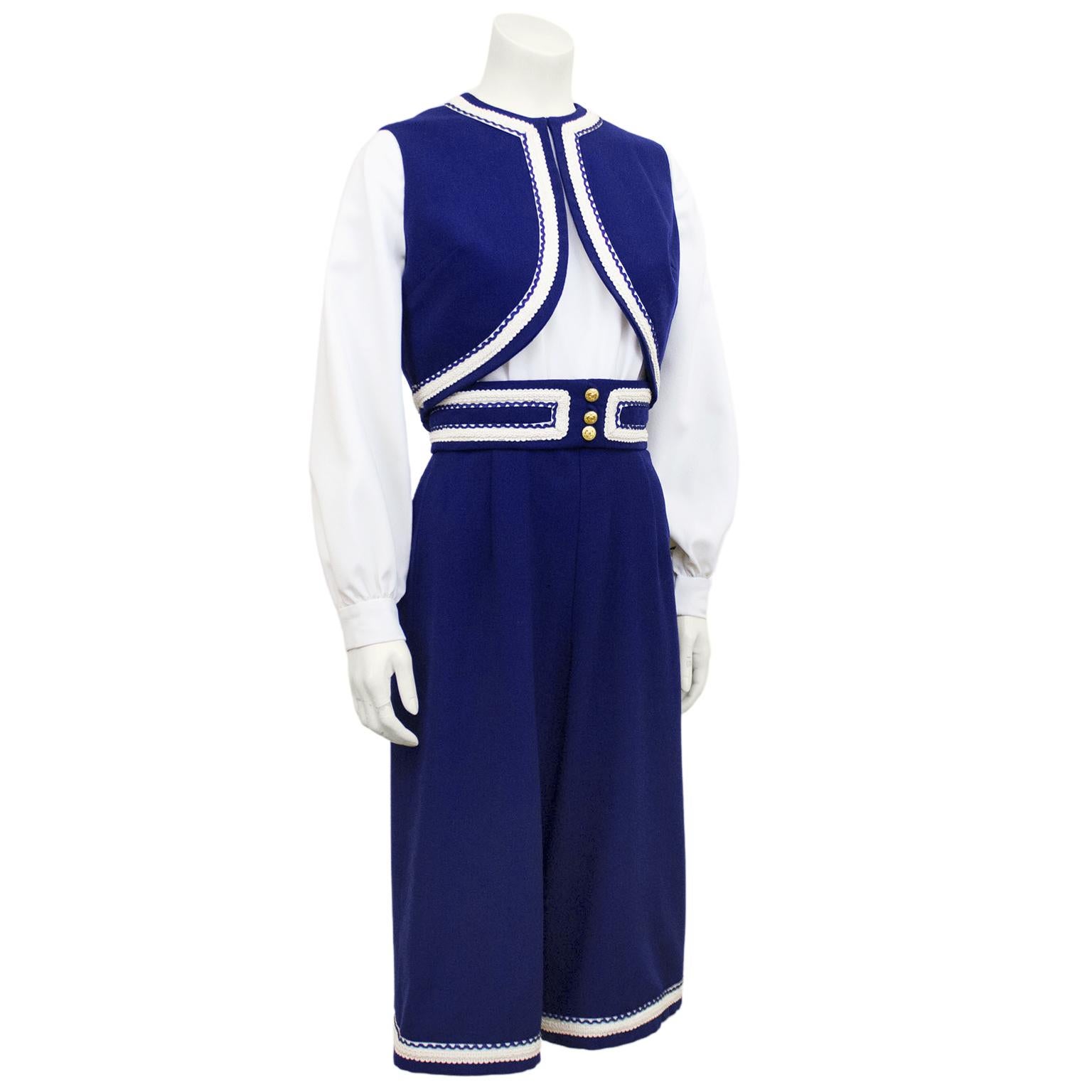 The most adorable 1960s Roger Frères cropped culotte jumpsuit and vest ensemble. The jumpsuit features a white crepe blouse with bishop sleeves and high waisted navy wool pants with ornate white trim. Waistband on pants features white and navy trim