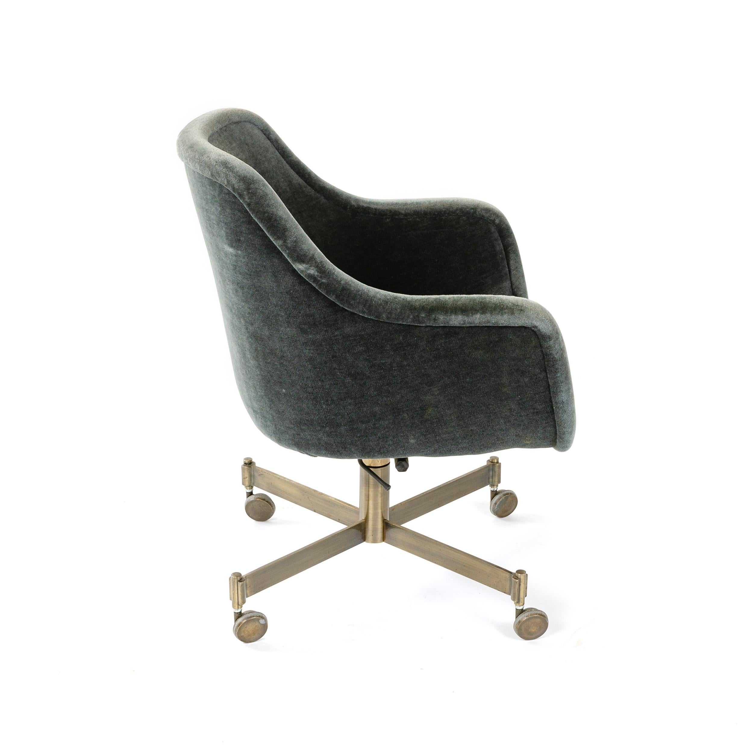 A rolling executive desk chair in vintage blue-grey mohair supported by a bronze-plated swivel base with casters.