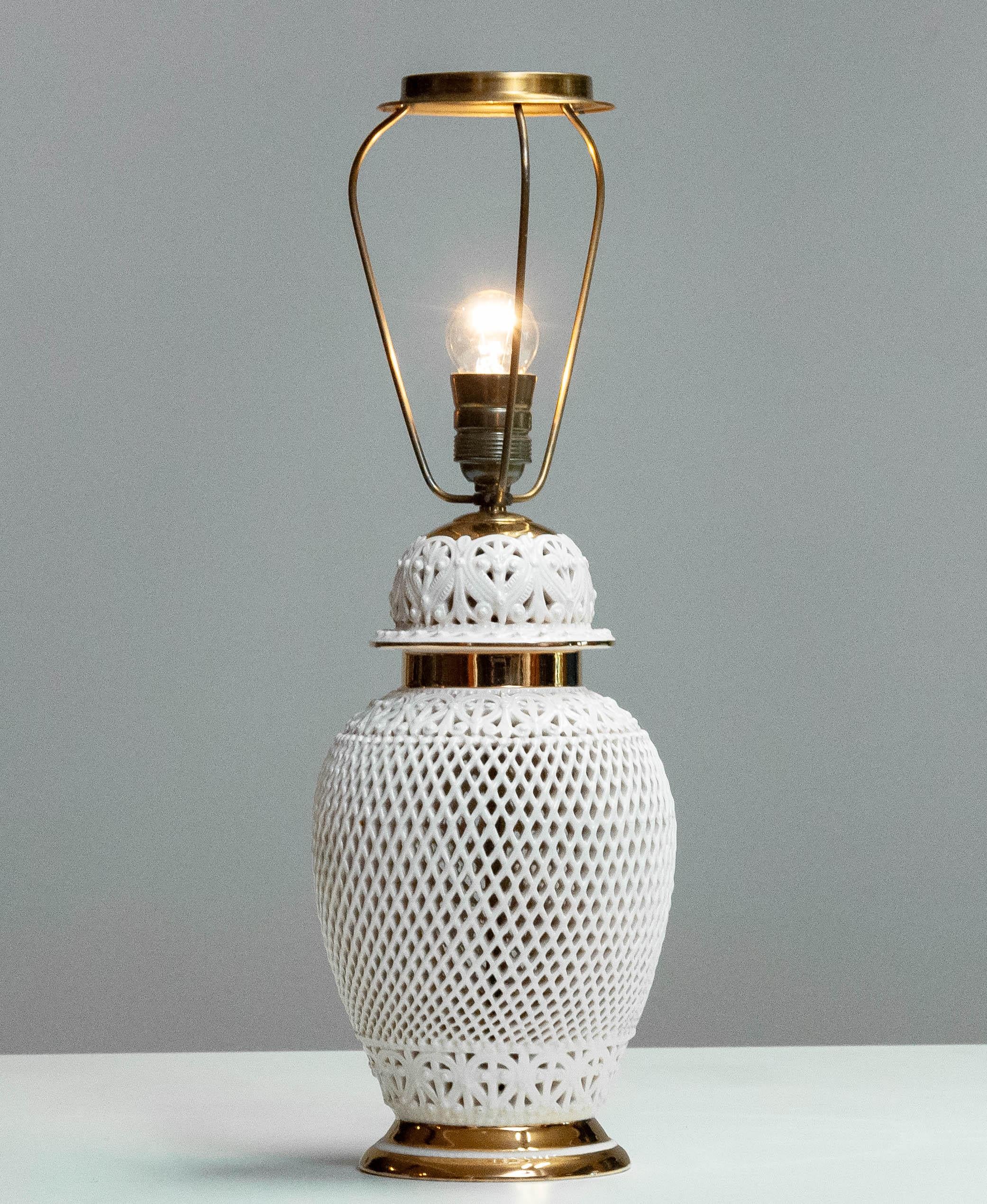 Openwork table lamp from the 1960s. This elegant piece features an intricate lattice design with gold accents, creating a refined and decorative lighting solution.  Of Italian origin, it combines vintage charm with a timeless aesthetic.