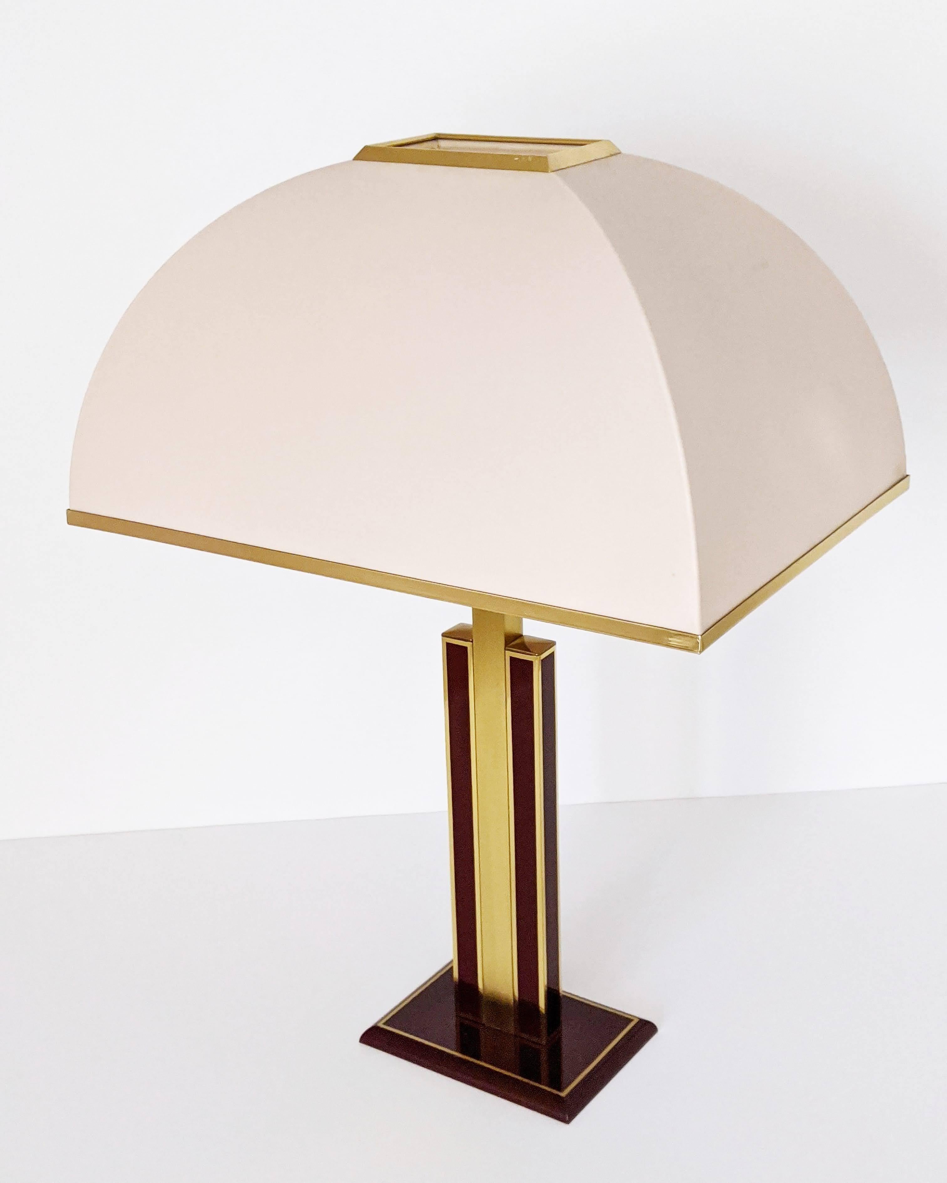 Rare and elegant Romeo Rega table lamp made of thick brass with original shade. 

Prime quality material, well made with superb attention to detail. 

Brass enameled in a dark red tone with a high gloss lacquered finish. 

Base measure: 21
