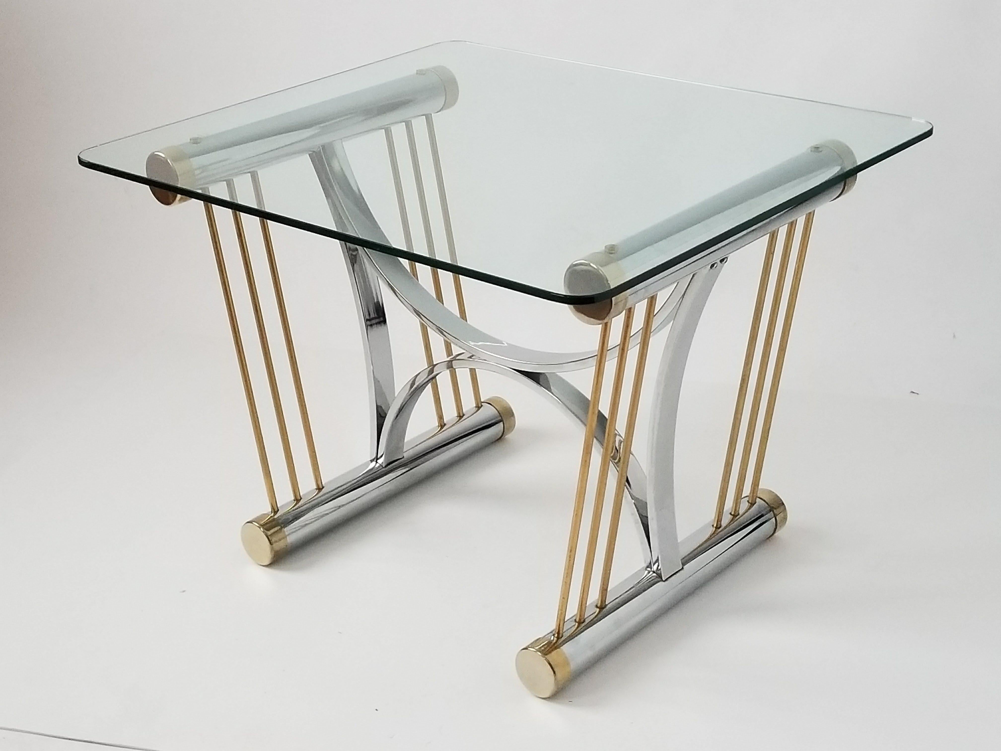 Art Deco style side table in the manners of Romeo Rega 

Thick 3\8 in. Glass sitting on a sculptural chrome and brass plated frame.

 