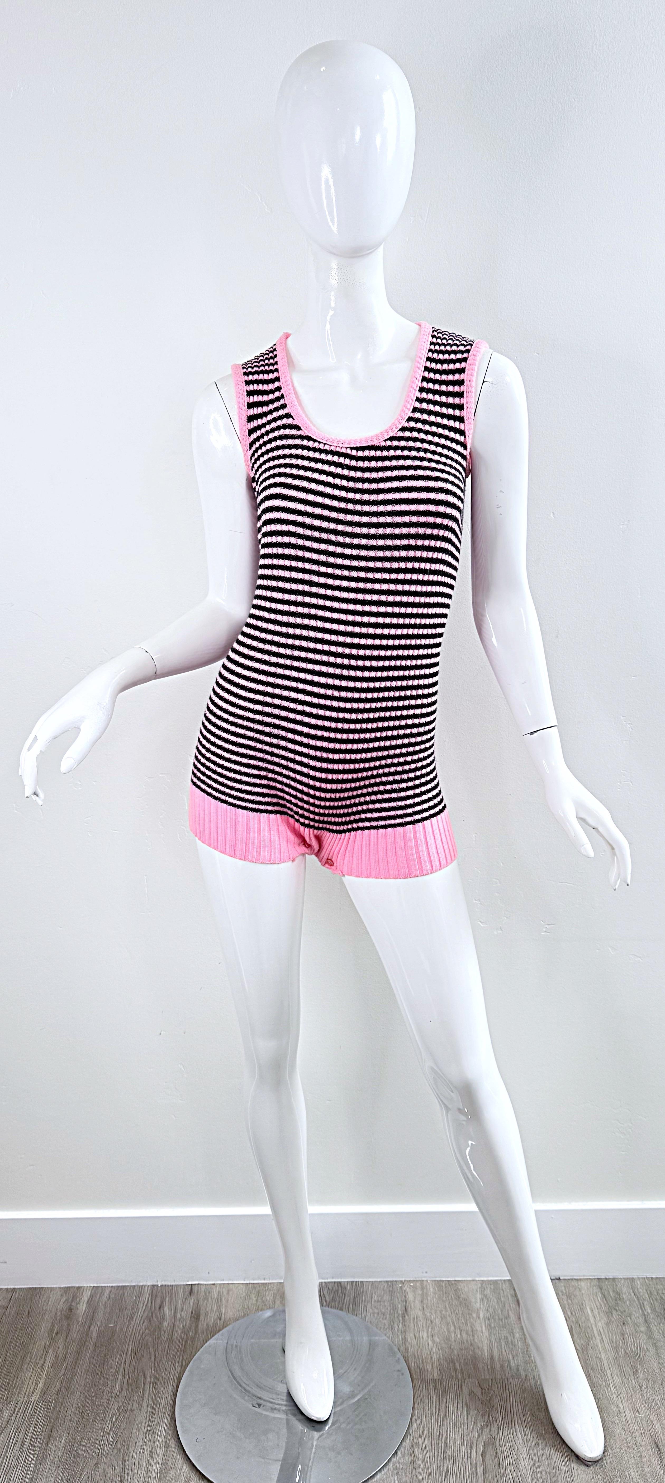 Super chic 1960s bubblegum pink and black striped romper onesie ! Features a soft knit fabric that offers plenty of stretch. Three hidden buttons at crotch. 
In great condition 
Approximately Size Medium / Large
Measurements: ( tons of stretch