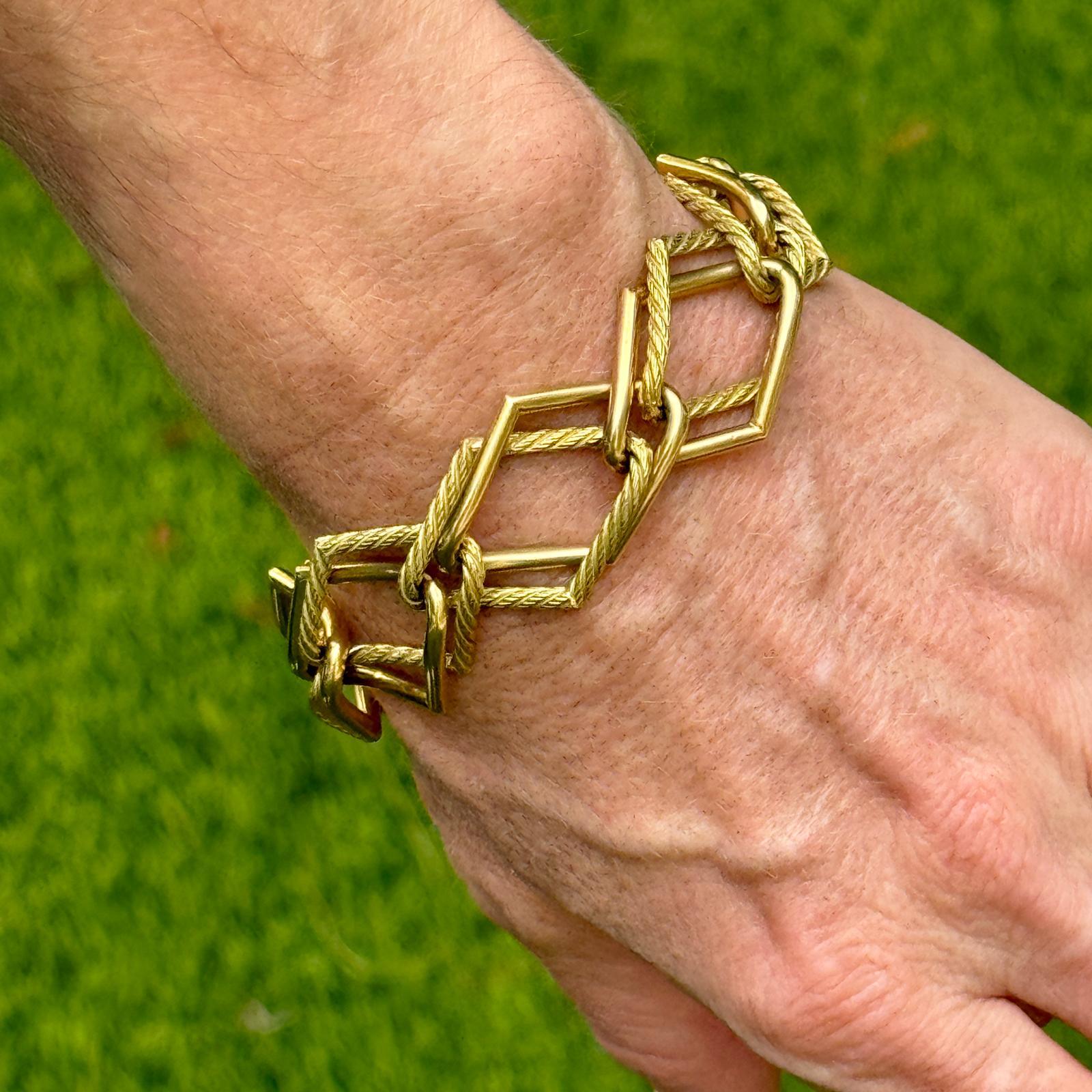 Fabulous 1960's vintage link bracelet crafted in 18 karat yellow gold. The textured rope and polished open links measure 8.00 inches in length and approximately .75 inches in width. The bracelet has not been polished to keep it's original patina