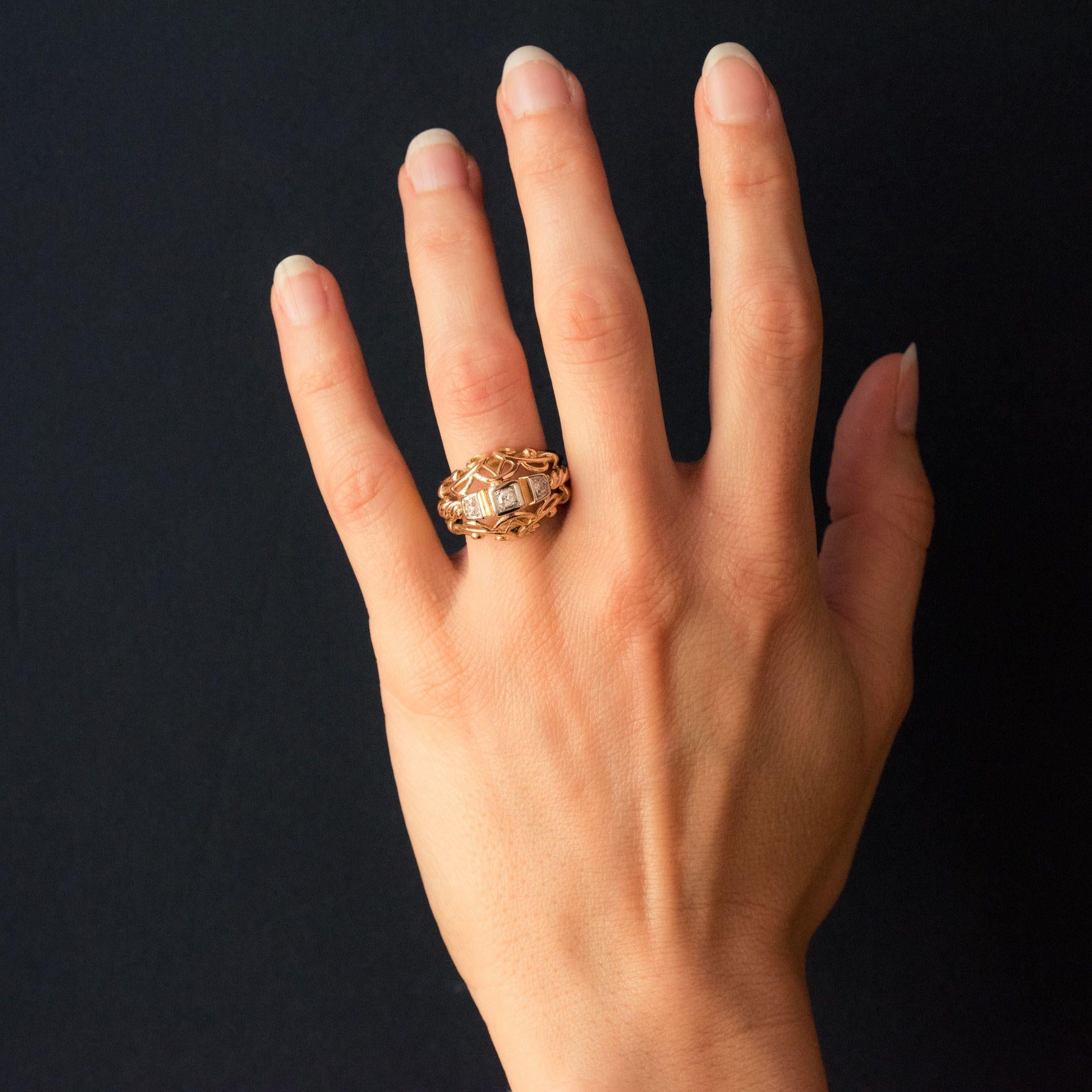 Ring in 18 karat rose gold. 
This splendid antique domed ring is composed of gold strands that are smooth, twisted and entwined with 3 diamonds set at the heart of a geometric design. 
Total diamond weight: about 0.20 carat.
Height: 1.45 cm,