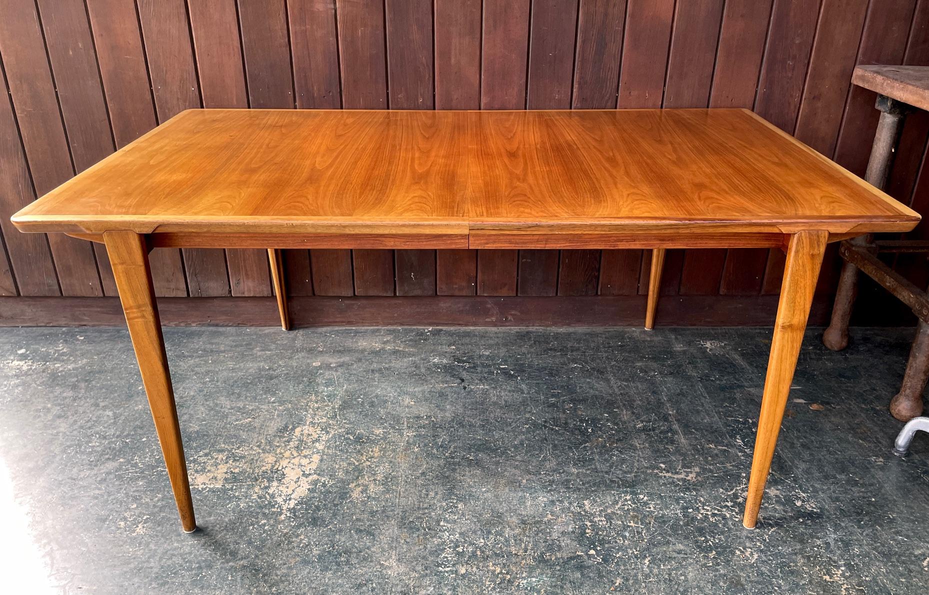Amazing design, very high quality craftsmanship and details, this was an artisan produced piece and distributed by Illums Bolighus, for Henry Rosengren Hansen. 

This teak dining table comes with two hidden leaves that store inside the table, each