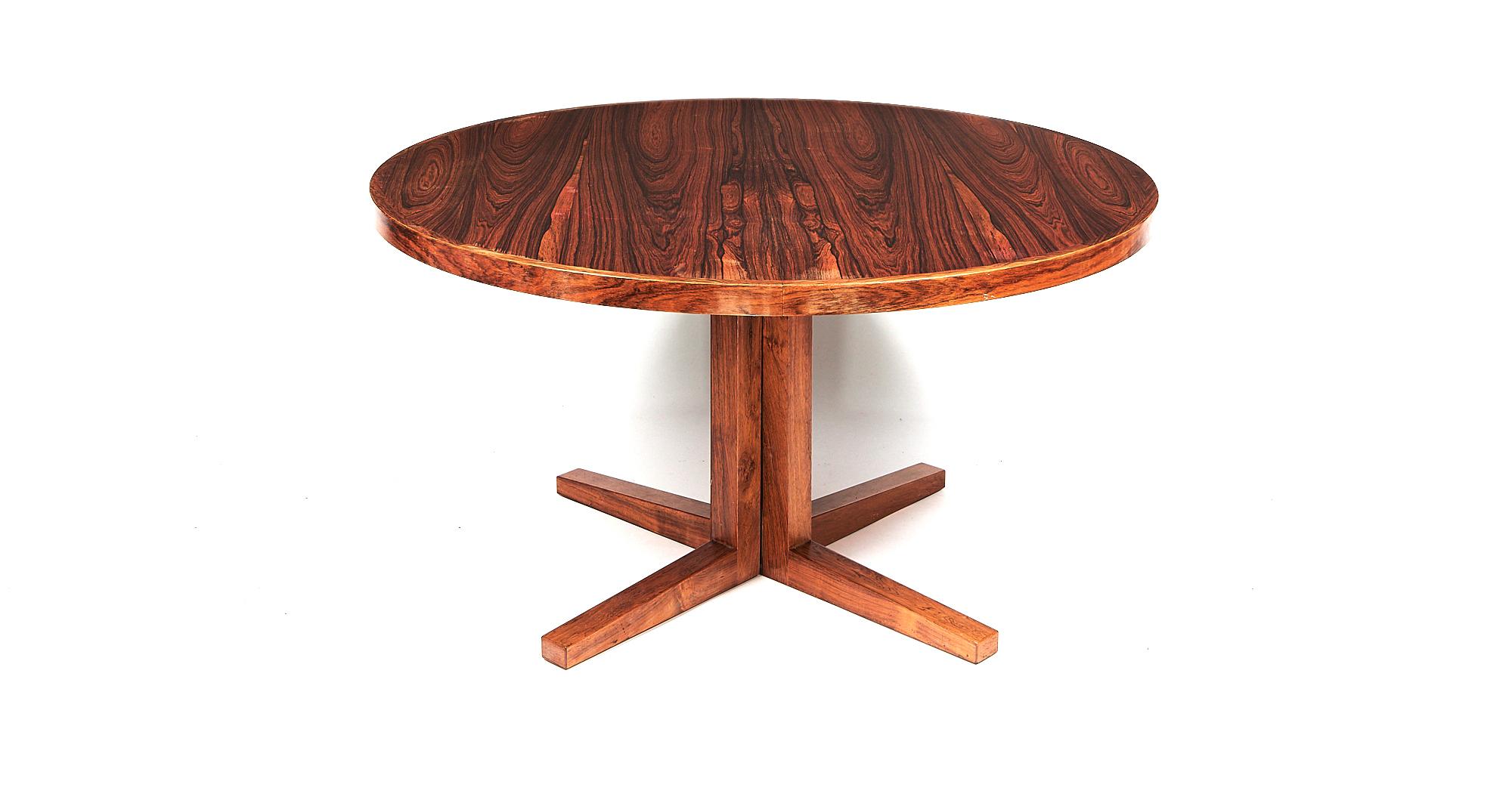 A 1960s rosewood extending dining table with two leaves by John Mortensen for Heltborg Møbler, Denmark
Without leaves the table is circular (diameter 130cm) but extends to 228cm long with the leaves added. The V shaped leg supports have been