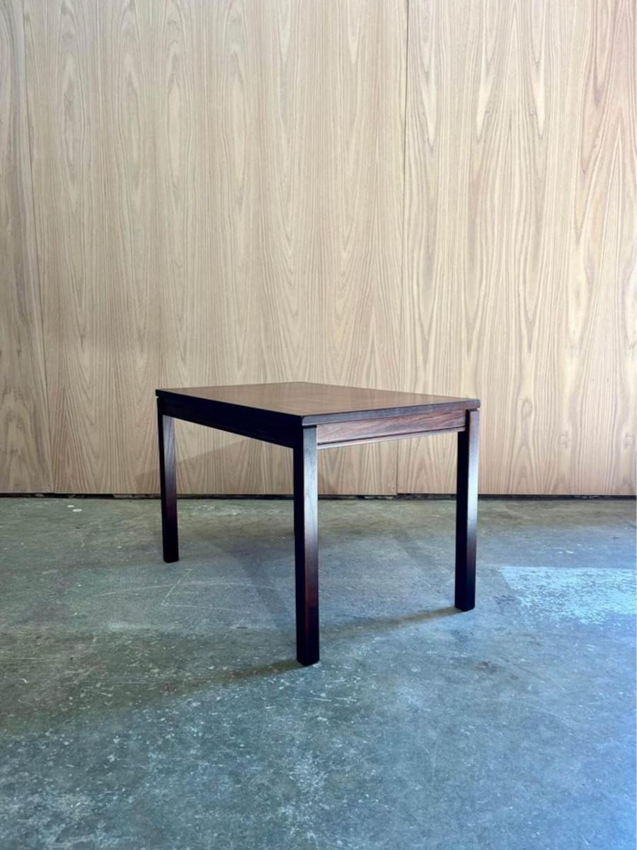 Introducing this 1960s rosewood side table by P.S. Heggen, made in Norway. Featuring a stunning checkerboard design with exquisite grain, this table exemplifies clean, simple lines and timeless Scandinavian design. Crafted with a rosewood veneer top