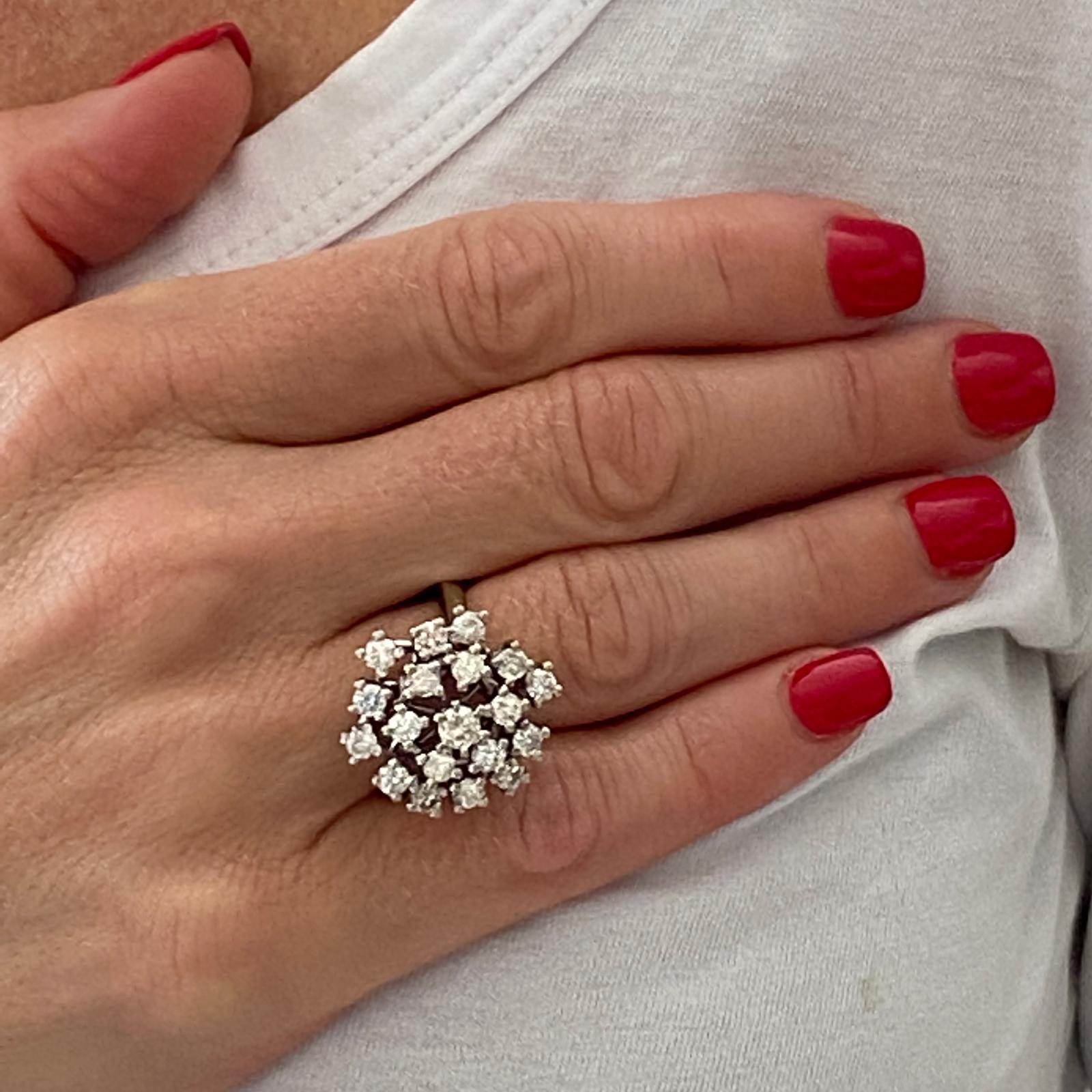 Diamond vintage snowflake ring fashioned in 14 karat white gold. The ring features 19 round brilliant cut diamonds weighing 2.00 carat total weight and graded H-J color and SI clarity. The ring measures 20mm in diameter and is currently size 7.75