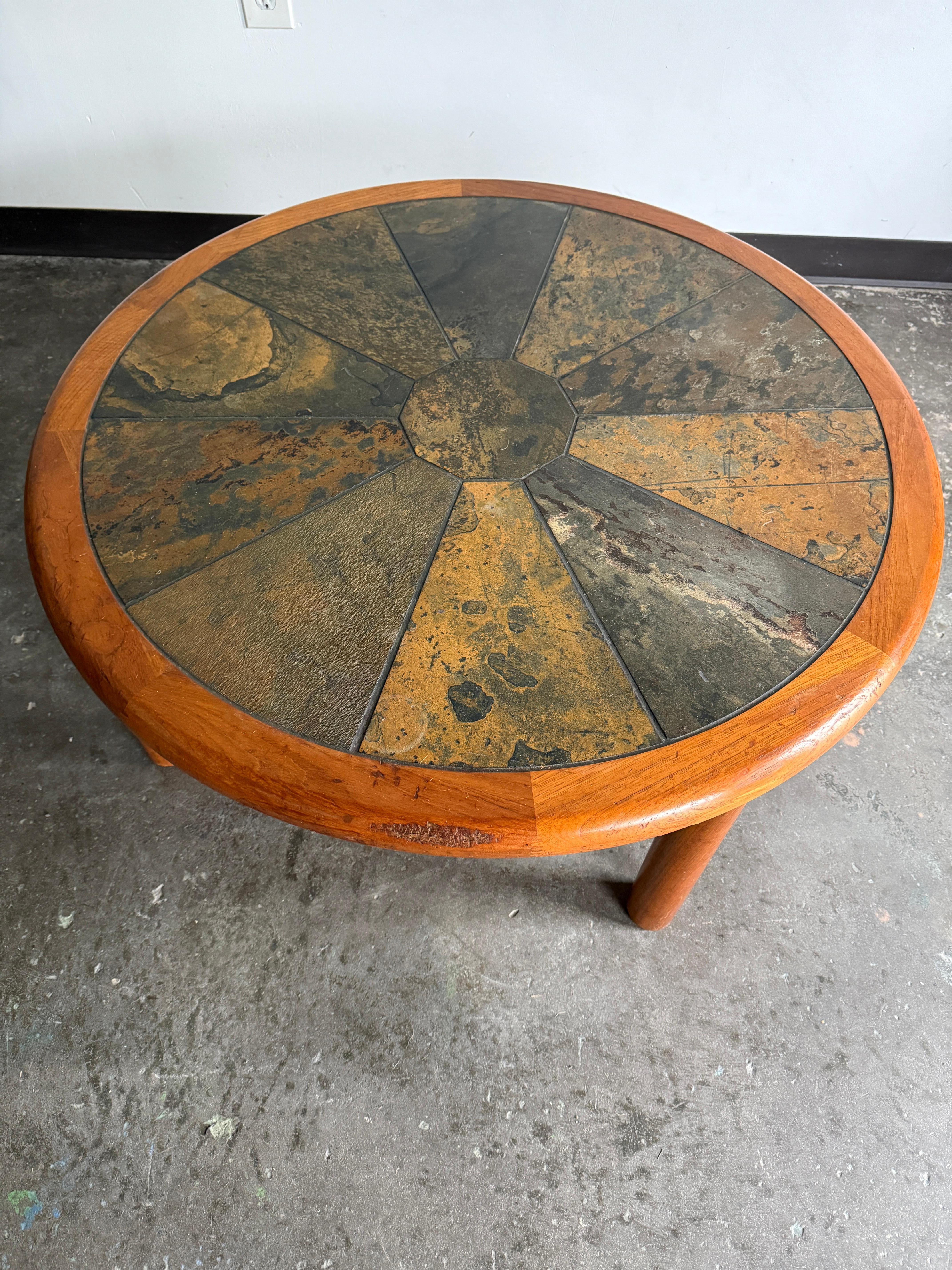 Beautiful teak and ceramic Tue Poulsen for Haslev coffee table in excellent vintage condition with minor age-consistent wear. Solid teak with curved edges and substantial cylindrical legs. With last for many decades to come.