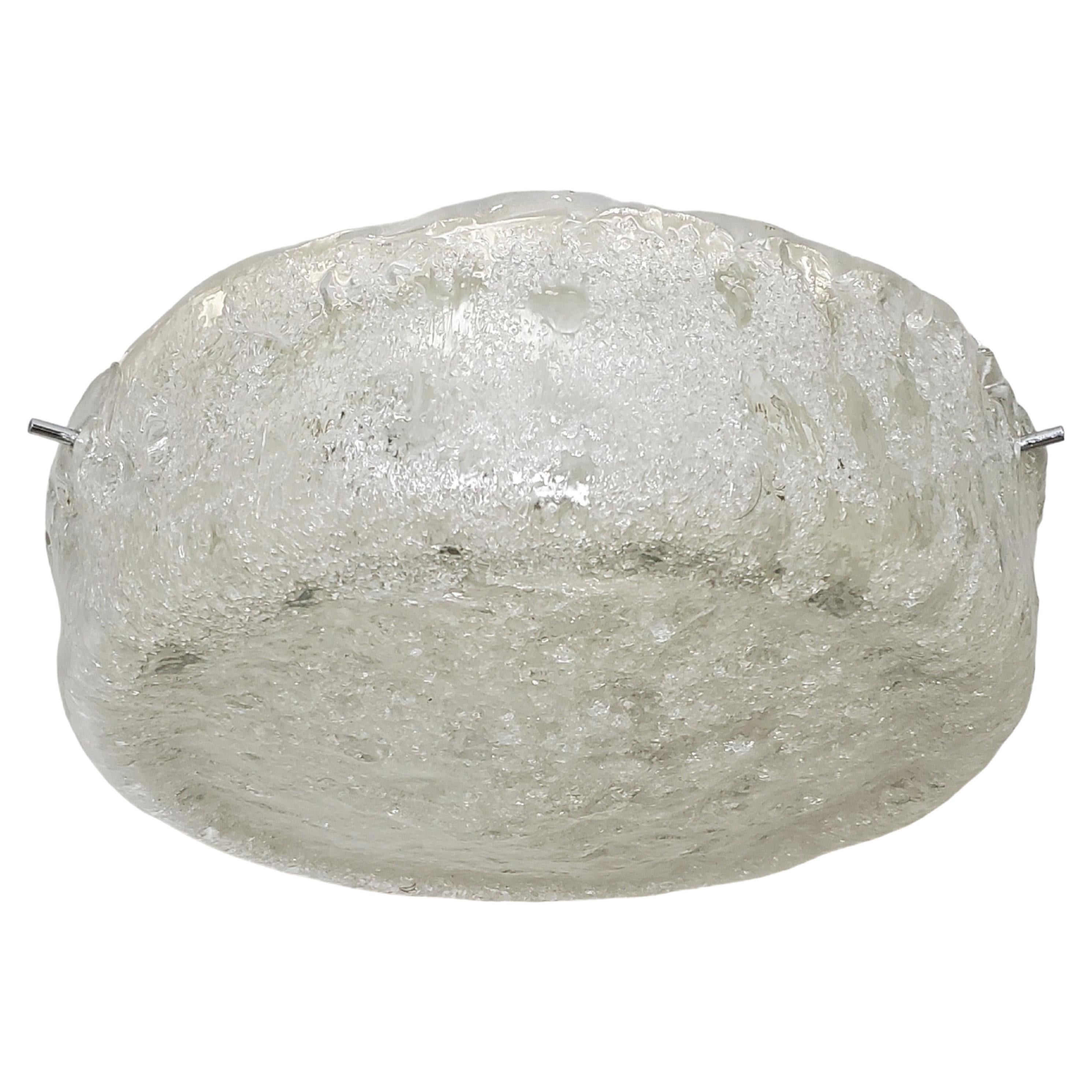  Mid-Century Modern round flush mount, circa ~1965,  attributed to Kaiser Leuchten showcases a thick, handmade glass shade. 
The shade, characterized by a clear and frosted textural surface, undulates and curves with consistent smoothness,