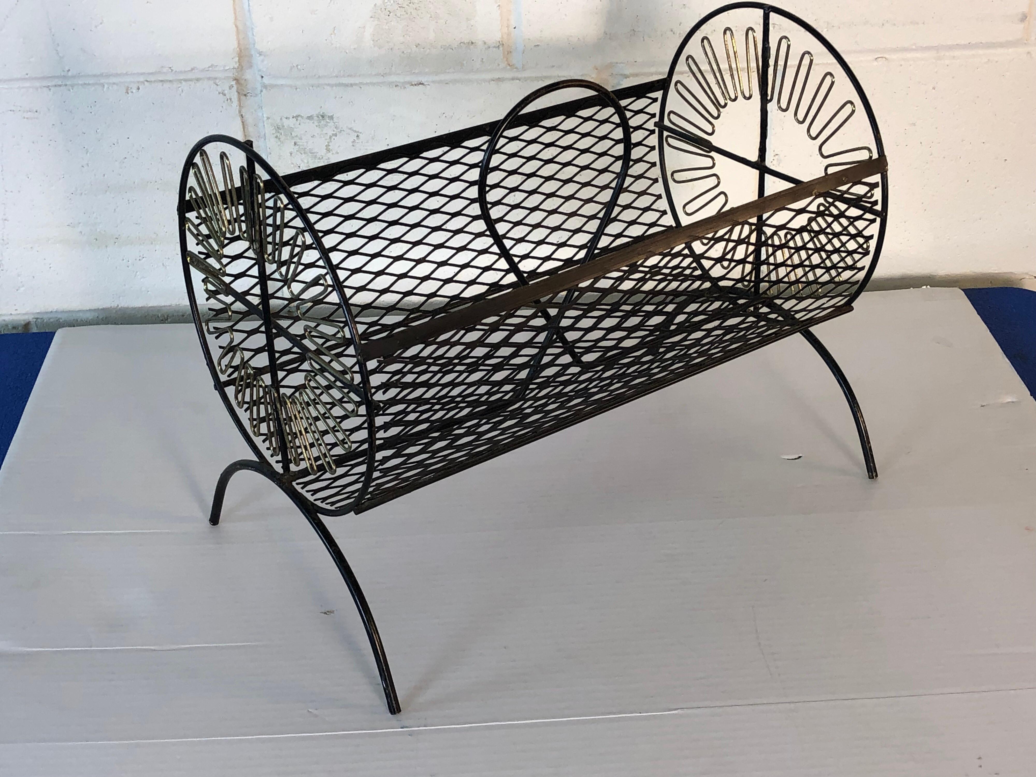 Vintage 1960s round black wire magazine rack with gold atomic metal accents on the ends. Magazine rack is in original condition with light wear from age and use. No marks.