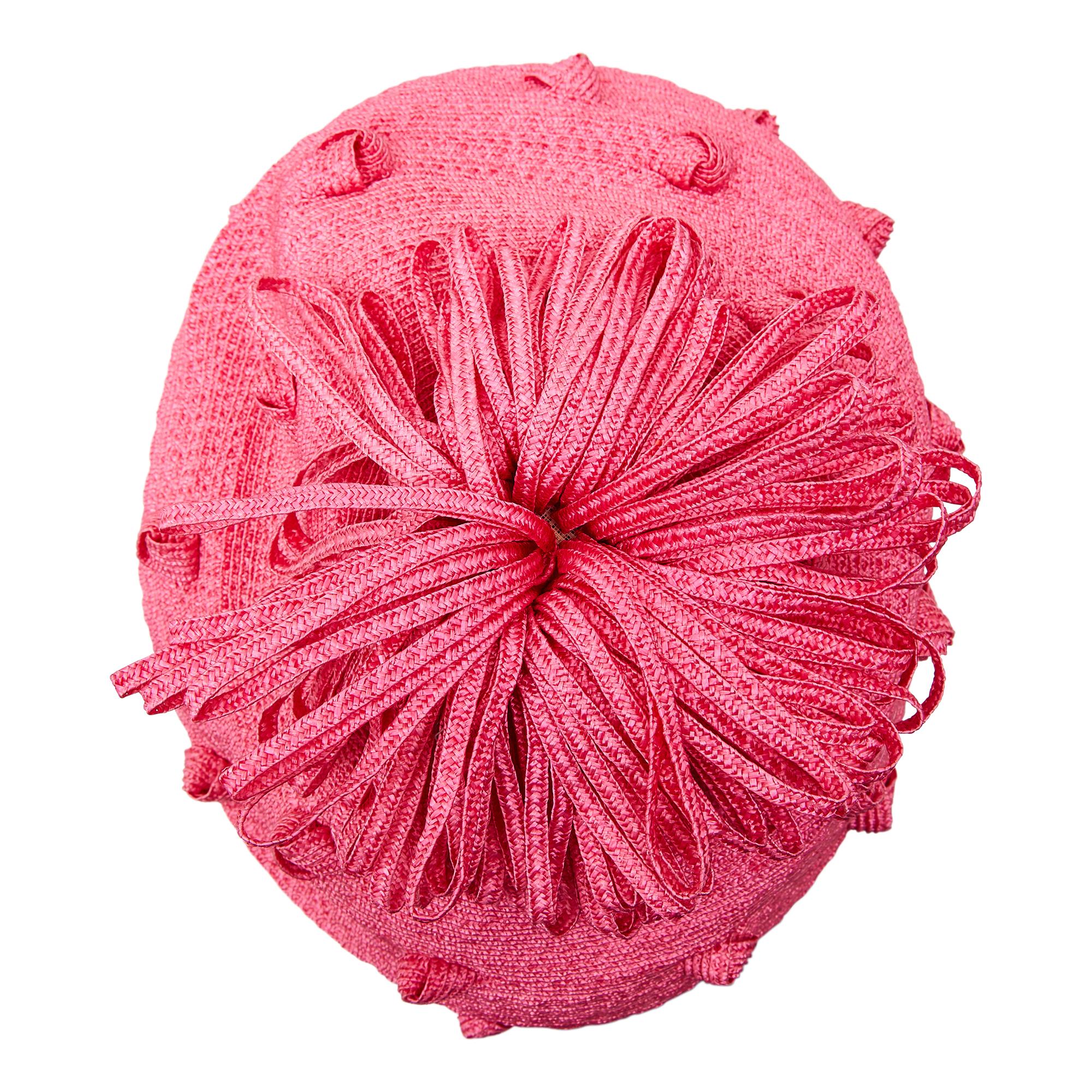 This is a really fun Simone Mirman straw bobble hat dating from the 1960s. The straw is in a bubble-gum pink, offset with quirky knotting throughout as well as a ruffle trim pom pom affixed to the top of the crown. This hat could be worn to the side
