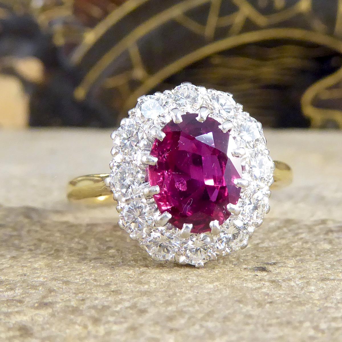 This 1960's Ruby cluster ring is in great condition especially for its age. It has been crafted with a stunningly bright and beautiful Ruby in the centre with a surround of 12 Brilliant Cut Diamonds weighing a total of 0.84ct. The Ruby itself is an