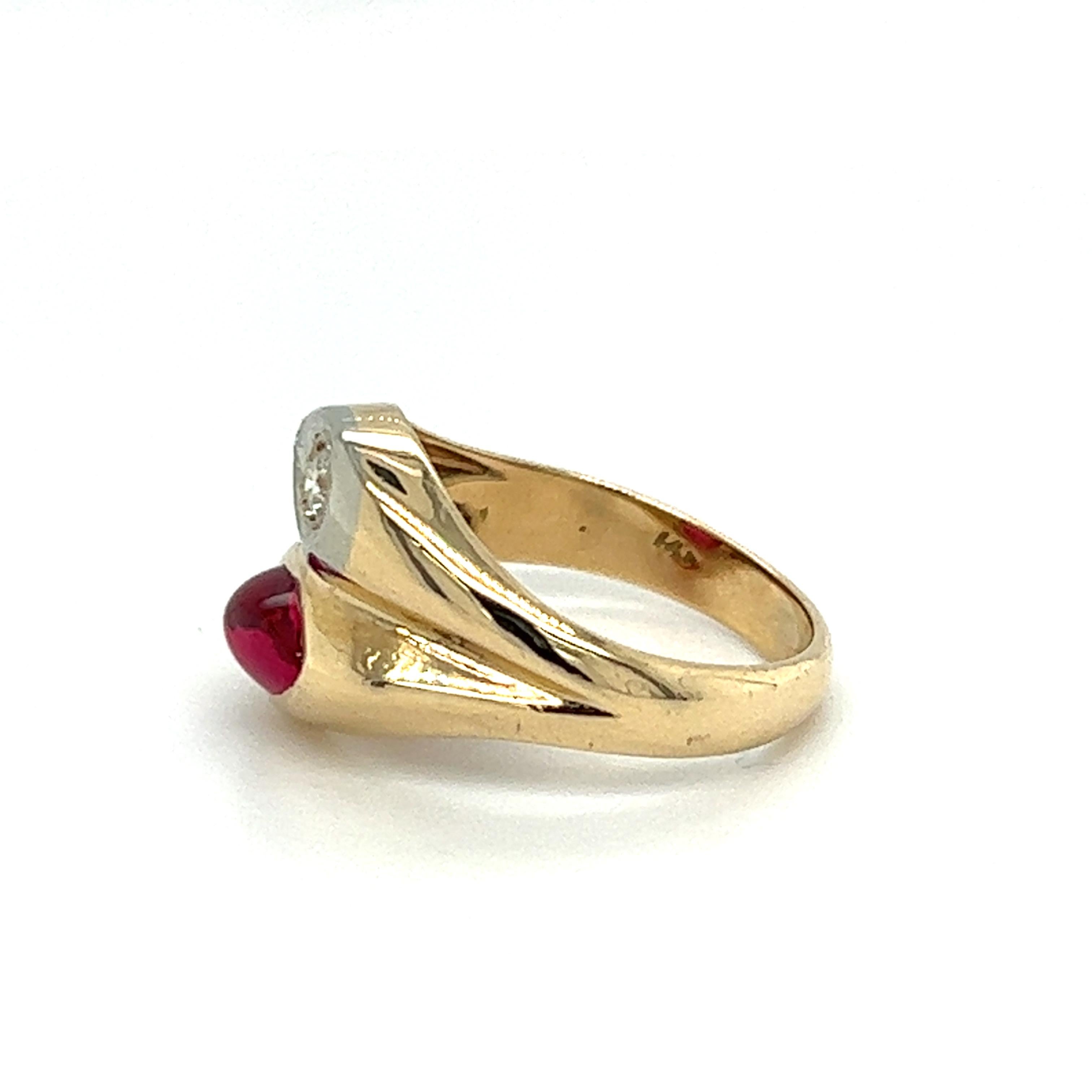 One 14-karat yellow and white gold yin-yang style ring featuring a pear-shaped cabochon created ruby measuring 7mm x 5 mm, and one natural round brilliant cut diamond, approximately 0.06-carat total weight with I/J color and SI1 clarity.  