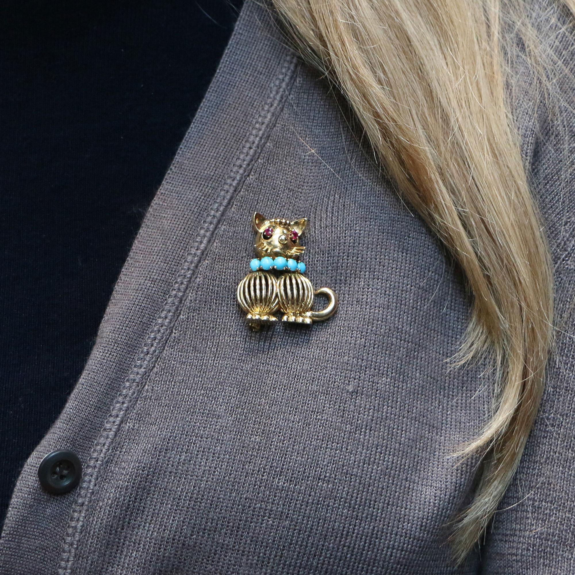 A quirky 1960's ruby and turquoise cat brooch by Hans Georg Mauntner, set in 18k yellow gold.

What immediately attracts your eye to this cute little cat is his brightly coloured blue turquoise collar. The collar is set with five equally sized round