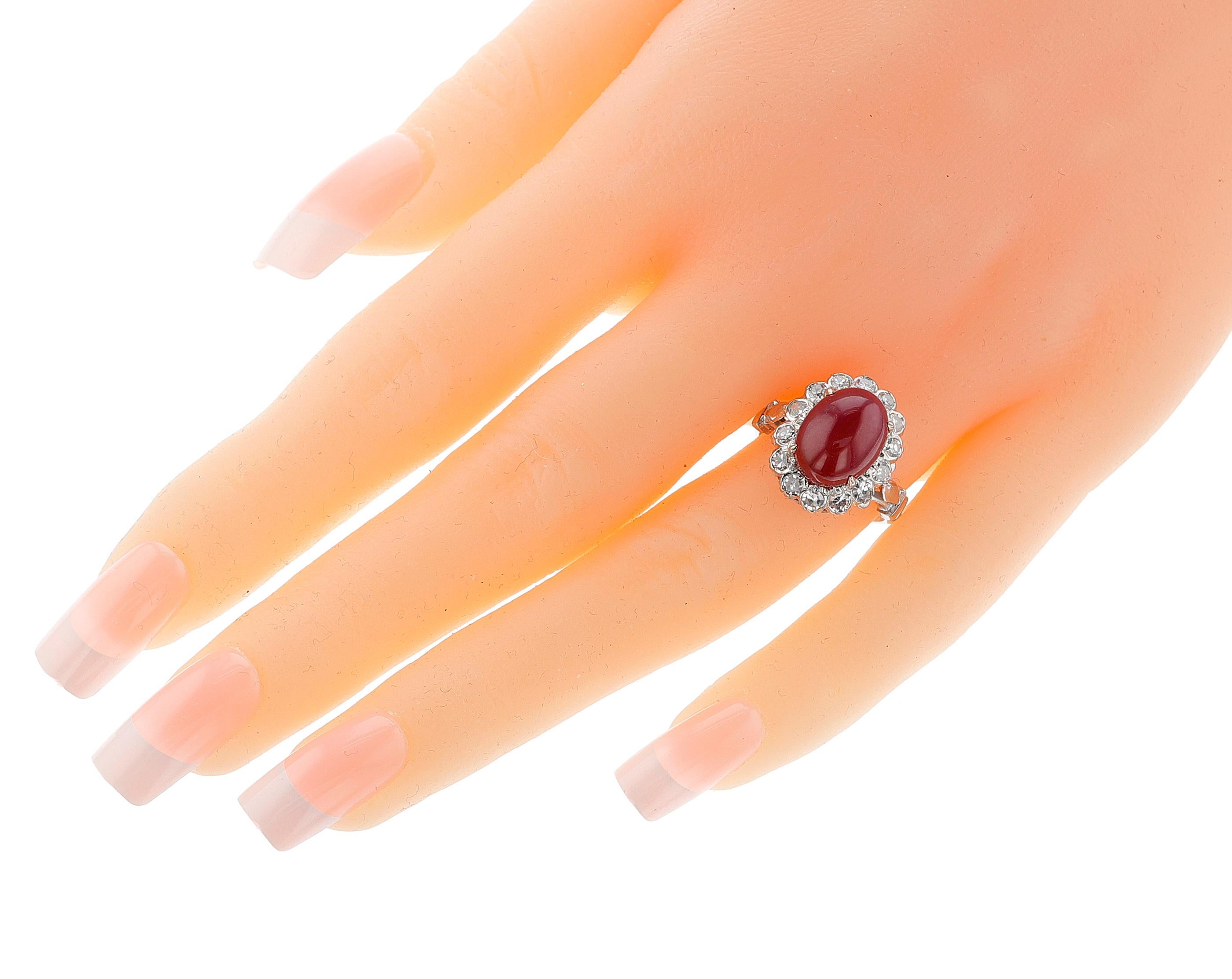 A 1960s Ruby Cabochon and Diamond Ring made in 14k White Gold. The ruby cabochon is 7 carats plus, 12MM x 9MM. The total weight of the ring is 5.11 grams. Ring size US 6.