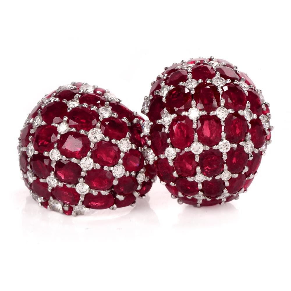 These stunning estate ruby and diamond clip-on earrings are crafted in solid platinum. Showcasing a beautiful cluster design of 80 prong set, GIA lab reported, genuine red rubies varying in sizes collectively weighing approx. 52.30 carats. Further